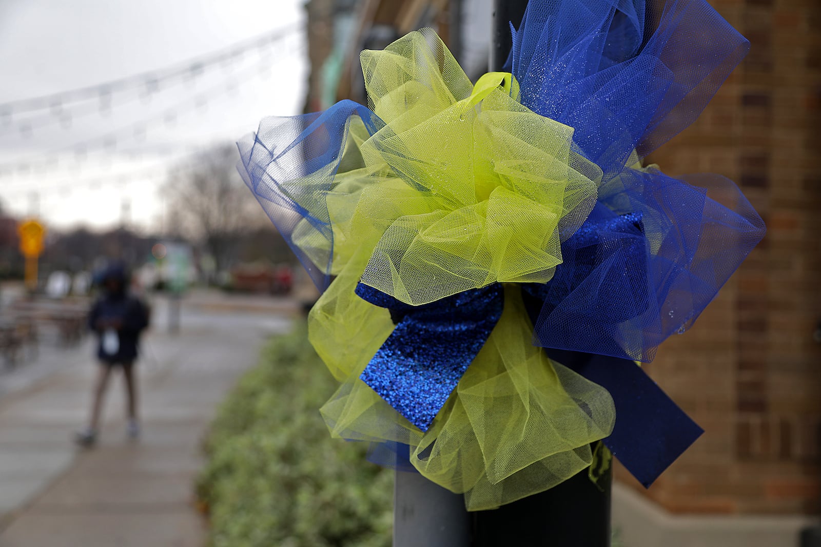 Blue and yellow ribbon tied around the lamp posts in downtown Springfield show the community's support for the Wildcats football team. BILL LACKEY/STAFF