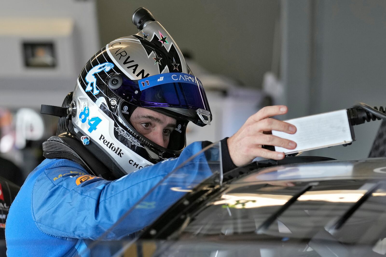 Jimmie Johnson checks his equipment before a practice for the NASCAR Daytona 500 auto race Wednesday, Feb. 12, 2025, at Daytona International Speedway in Daytona Beach, Fla. (AP Photo/Chris O'Meara)