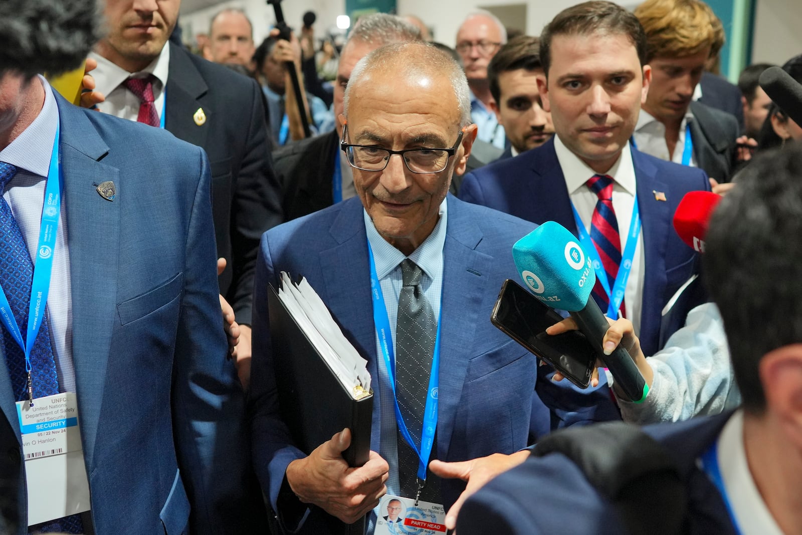 John Podesta, U.S. climate envoy, walks through a crowd during the COP29 U.N. Climate Summit, Saturday, Nov. 23, 2024, in Baku, Azerbaijan. (AP Photo/Peter Dejong)