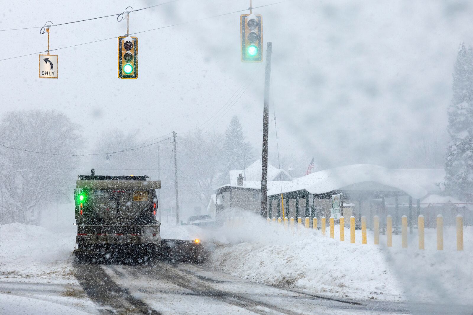 A plow removes snow from M-42 in Antrim County, Mich. on Sunday, Dec. 1, 2024. (Joel Bissell/Kalamazoo Gazette via AP)