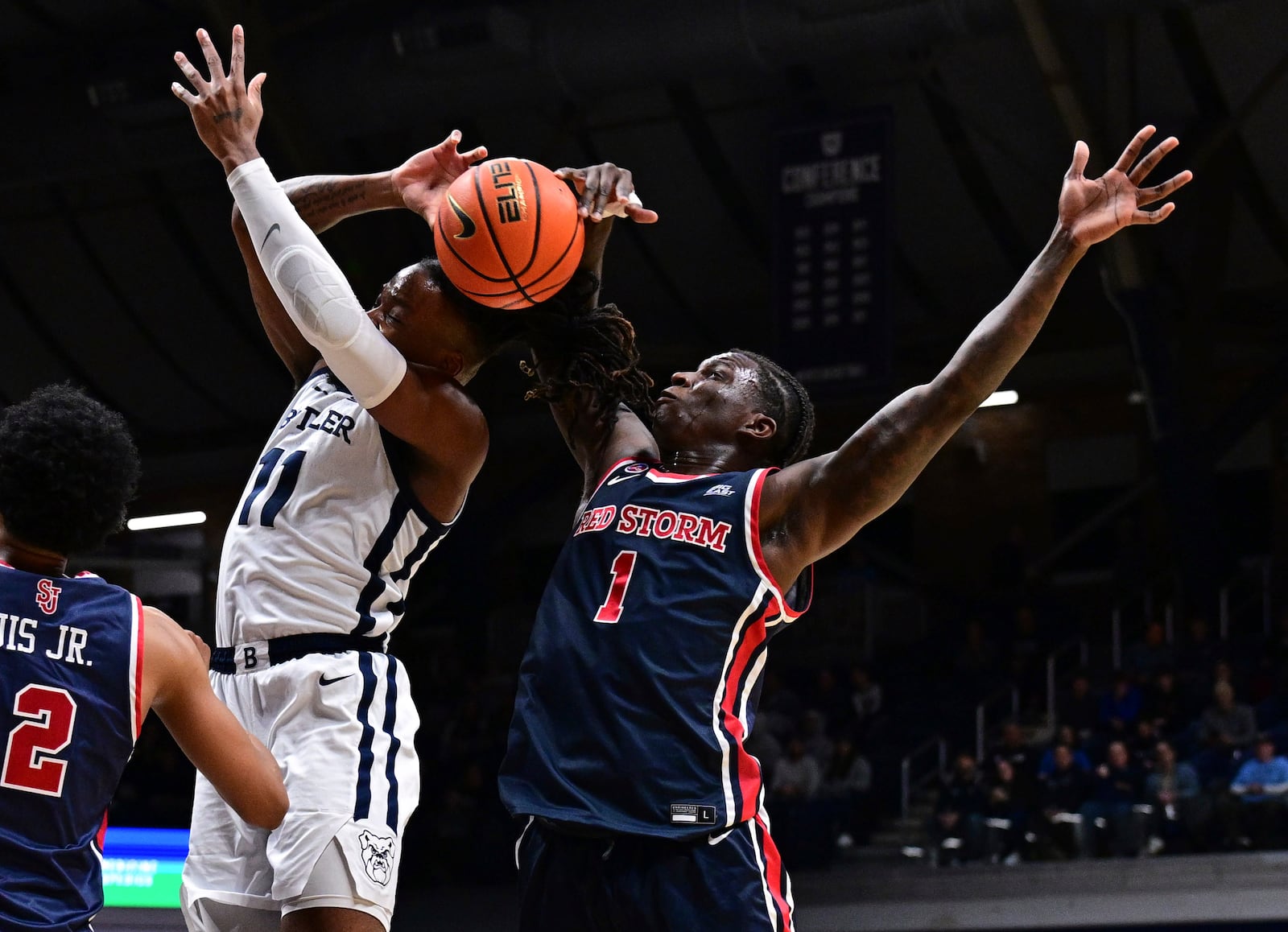 St. John's guard Kadary Richmond (1) blocks a shot by Butler forward Jahmyl Telfort (11) during the first half of an NCAA college basketball game, Wednesday, Feb. 26, 2025, in Indianapolis, Ind. (AP Photo/Marc Lebryk)