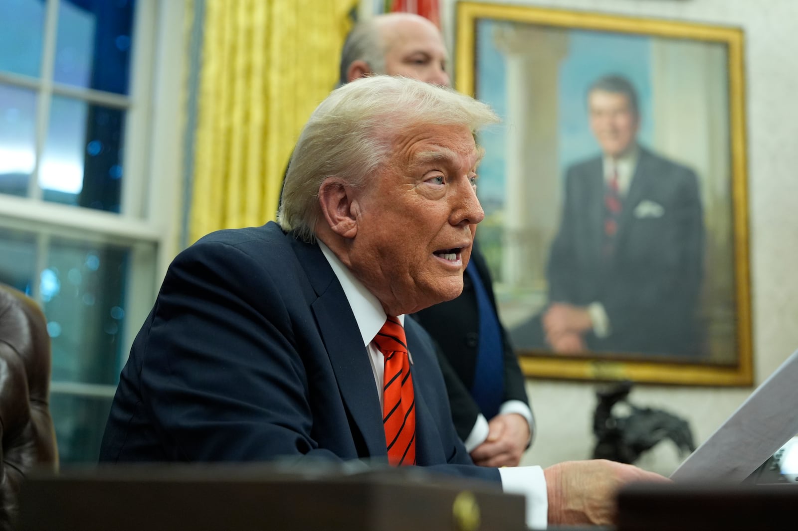 President Donald Trump speaks with reporters as he signs executive orders in the Oval Office at the White House, Monday, Feb. 10, 2025, in Washington. (Photo/Alex Brandon)