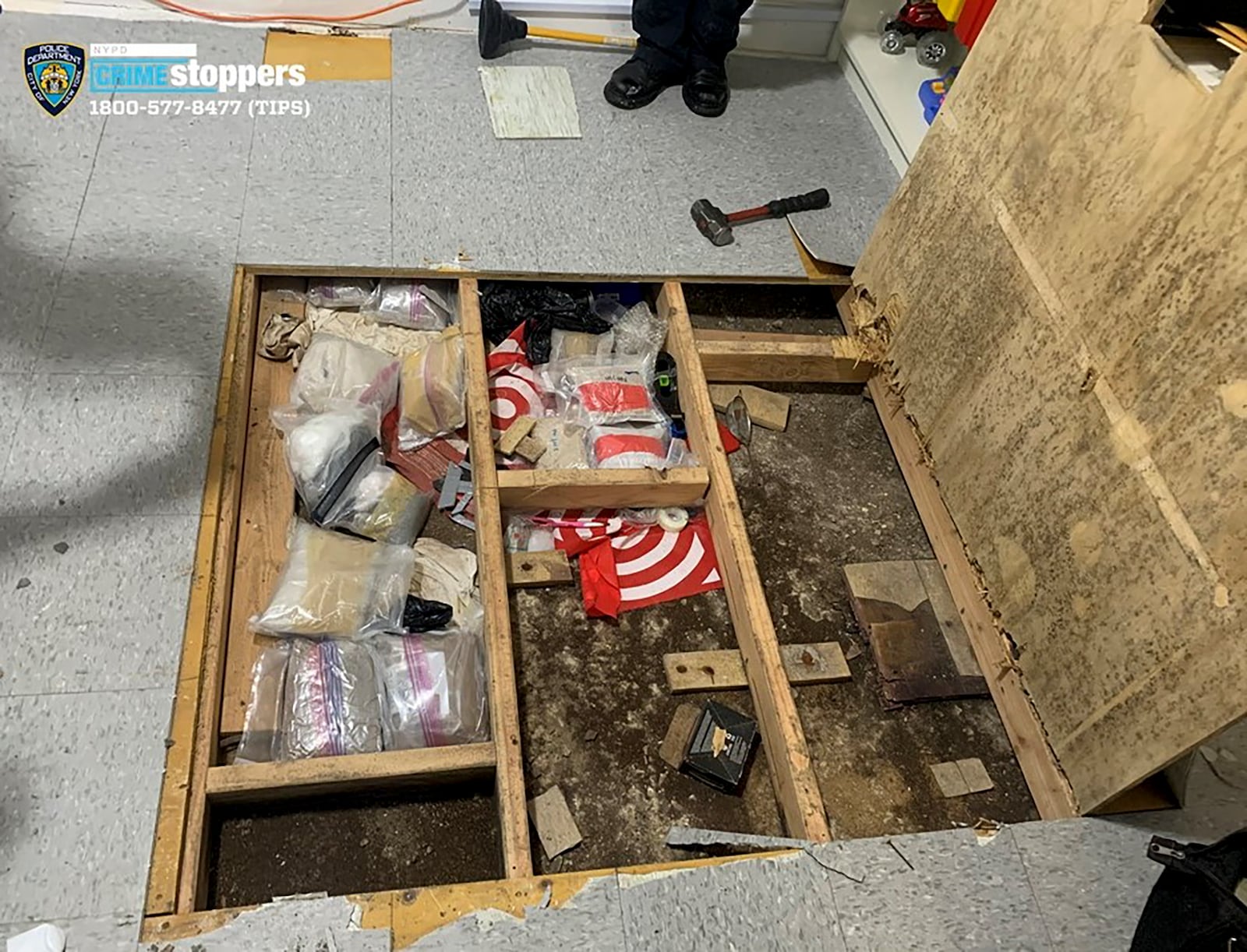 FILE0 In this photo provided by the New York City Police Department, a trap door leans open over narcotics, including fentanyl, and drug paraphernalia stored in the floor of a day care center, Thursday, Sept. 21, 2023, in New York. (NYPD via AP, File)