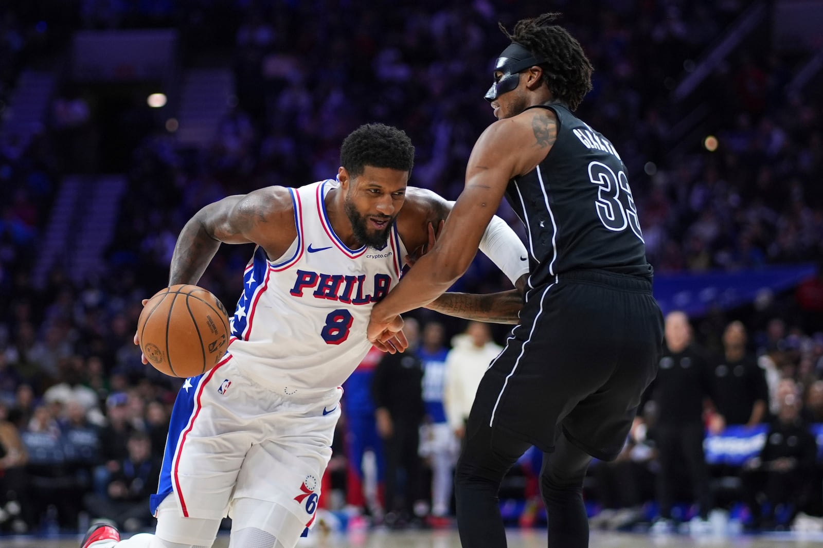 Philadelphia 76ers' Paul George, left, tries to get past Brooklyn Nets' Nic Claxton during the second half of an NBA basketball game, Saturday, Feb. 22, 2025, in Philadelphia. (AP Photo/Matt Slocum)