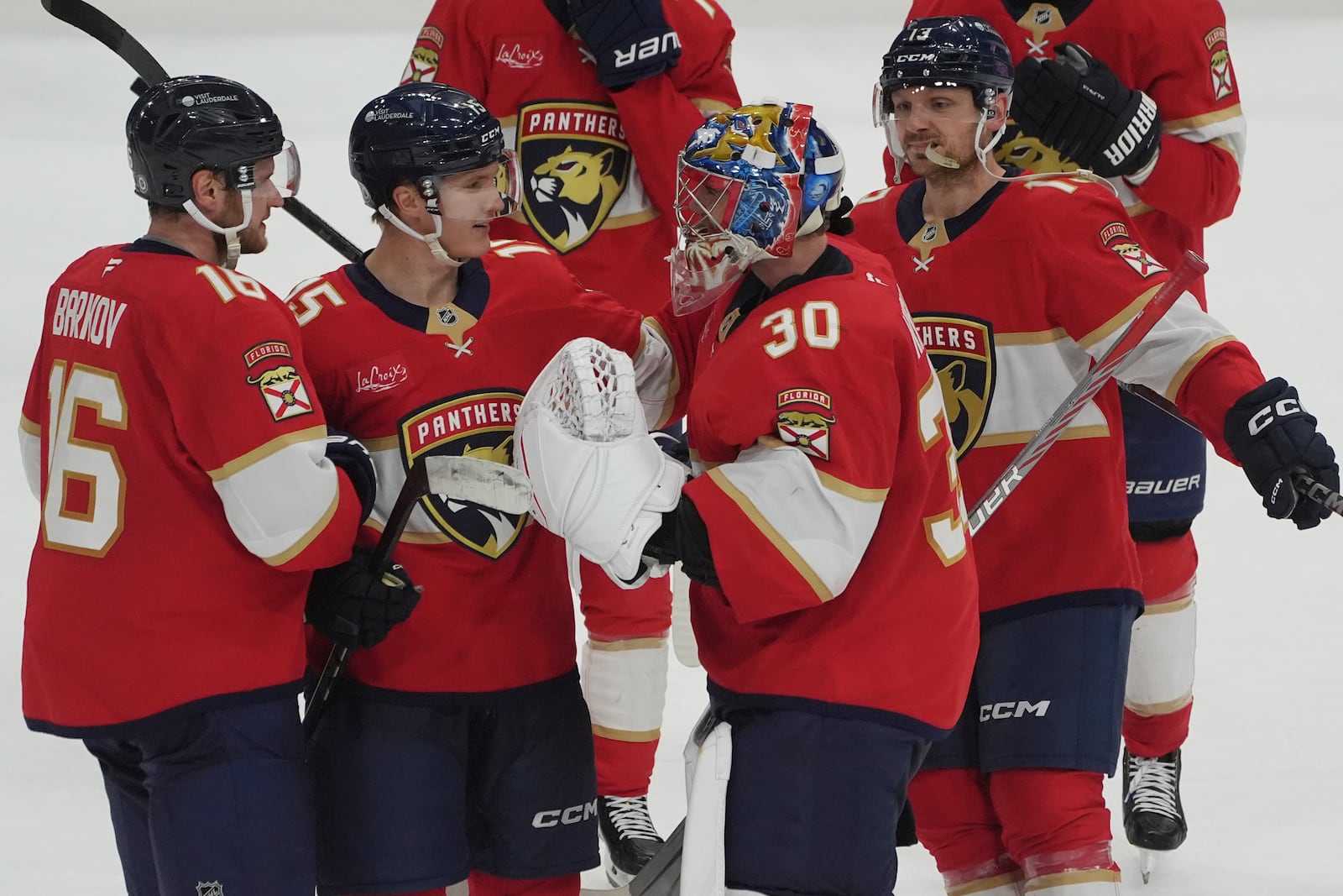 Florida Panthers goaltender Spencer Knight (30) celebrates with the team after defeating the Pittsburgh Penguins in a shootout at an NHL hockey game, Friday, Jan. 3, 2025, in Sunrise, Fla. (AP Photo/Marta Lavandier)