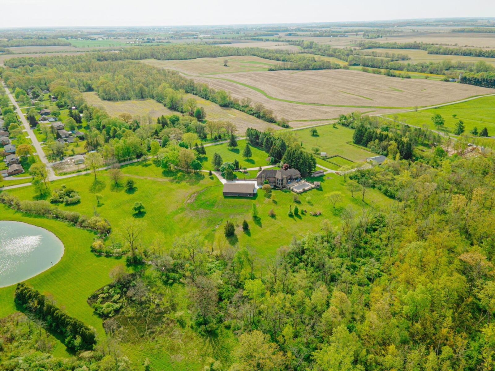 This in an overview of the property on nearly 43 acres; it's partially wooded with a spring-fed, stocked pond, main residence and commercial space as well as a barn, pasture and stable.