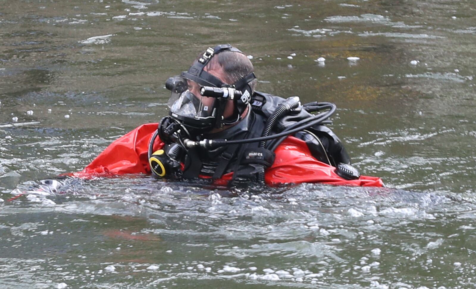 A member of the Wright Patterson Underwater Recovery Team dives searches Buck Creek for a missing man Friday, July 15, 2022.
BILL LACKEY/STAFF