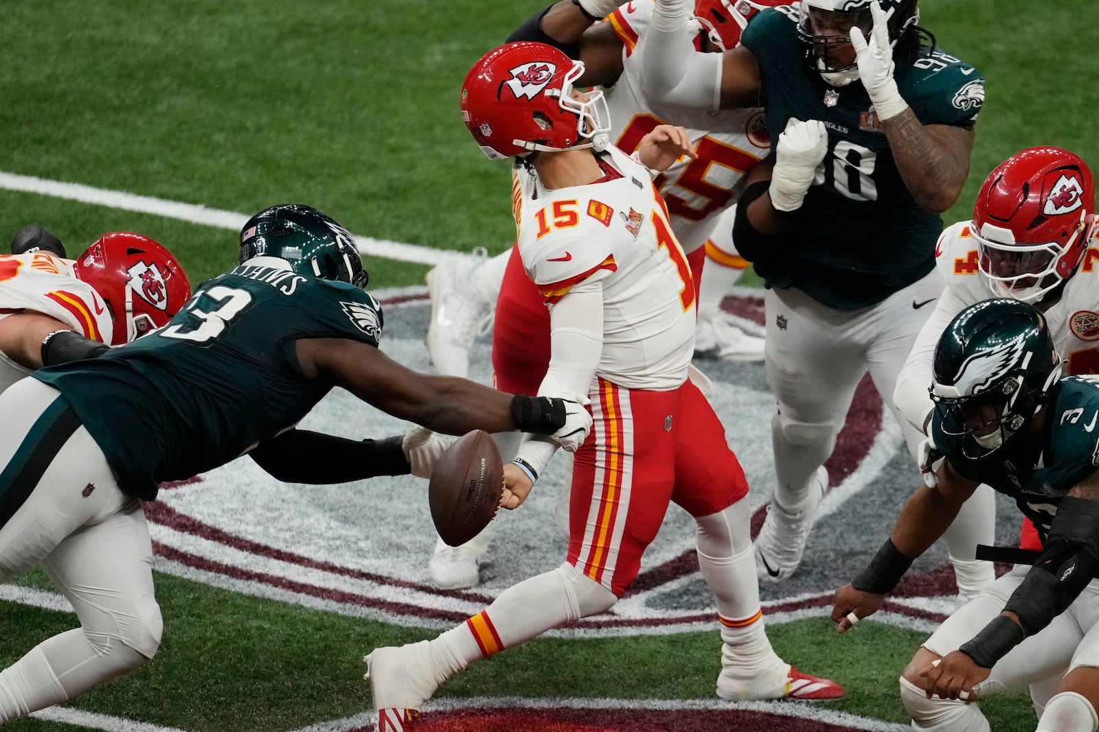 Philadelphia Eagles defensive tackle Milton Williams, left, strips the ball from Kansas City Chiefs quarterback Patrick Mahomes (15) during the second half of the NFL Super Bowl 59 football game, Sunday, Feb. 9, 2025, in New Orleans. (AP Photo/Gerald Herbert)