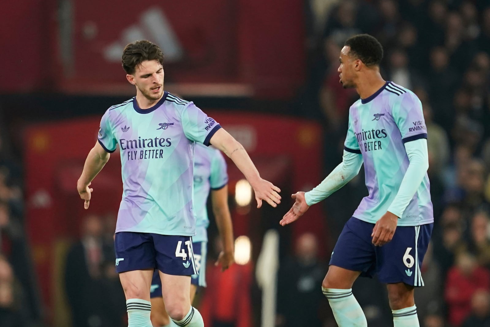 Arsenal's Declan Rice, left, is congratulated by Gabriel after scoring his side's first goal during the English Premier League soccer match between Manchester United and Arsenal at Old Trafford stadium in Manchester, England, Sunday, March 9, 2025. (AP Photo/Dave Thompson)