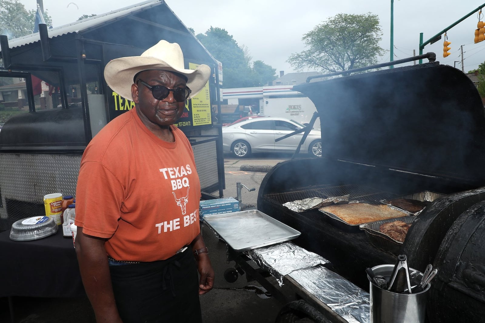 Richard Riddle, owner of Riddle's Ribs/Texas Cowboy Barbeque, cooking at the grill. Bill Lackey/Staff