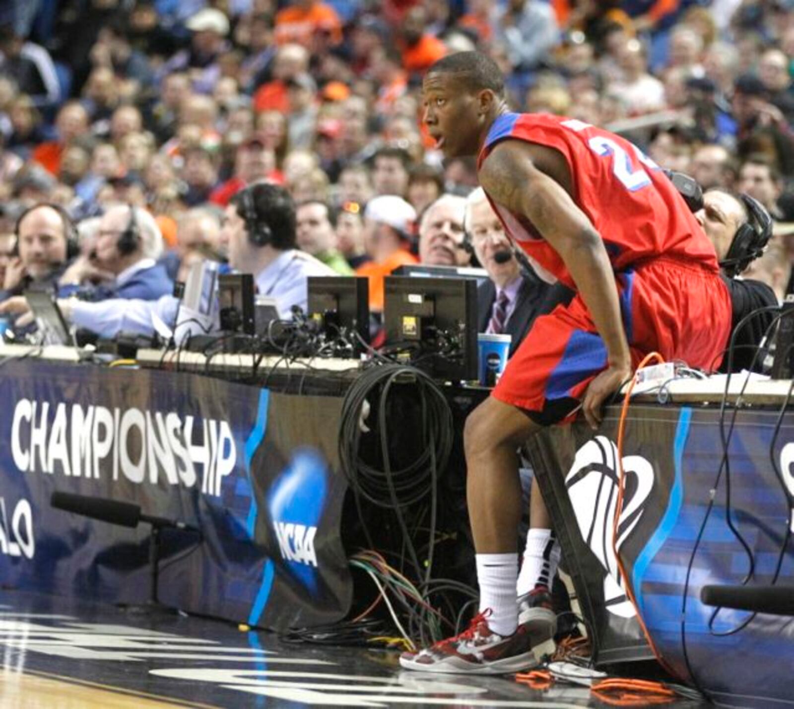 Dayton's Jordan Sibert falls onto press row in the second round of the NCAA tournament on Thursday, March 20, 2014, at the First Niagara Center in Buffalo, N.Y.