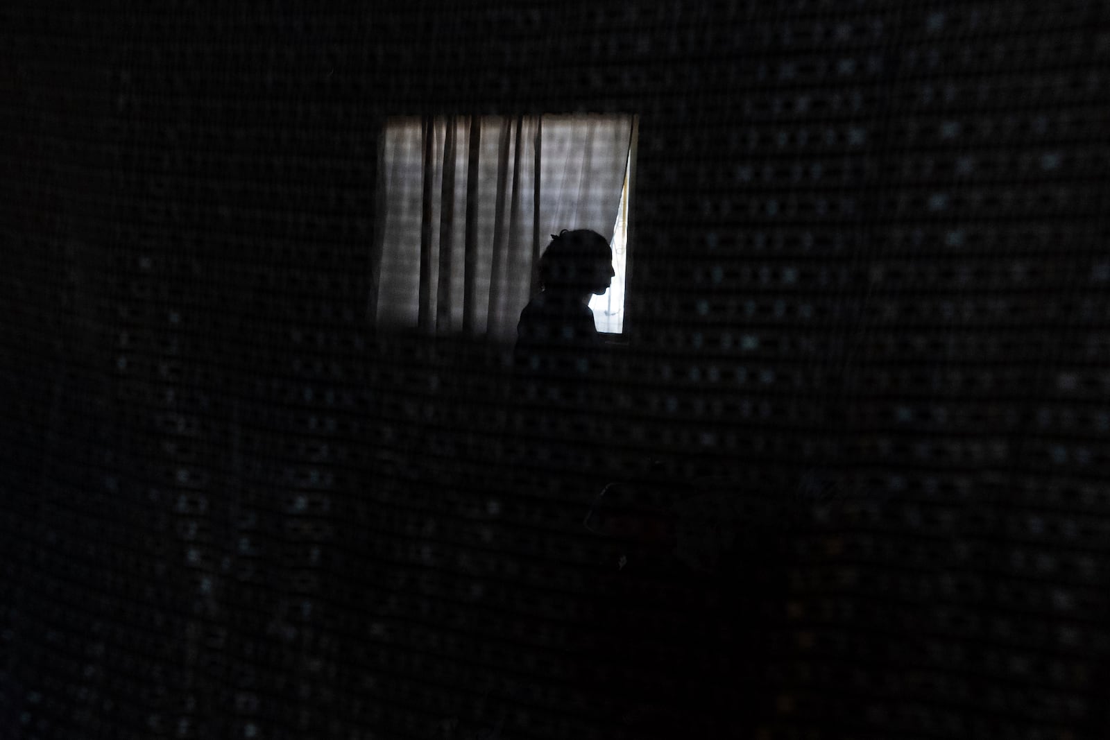 A Cuban migrant stands in a room at Martha Rosales' house as she waits for an appointment to apply for asylum in the United States through the CBP One app Wednesday, May 22, 2024, in Tijuana, Mexico. (AP Photo/Gregory Bull)