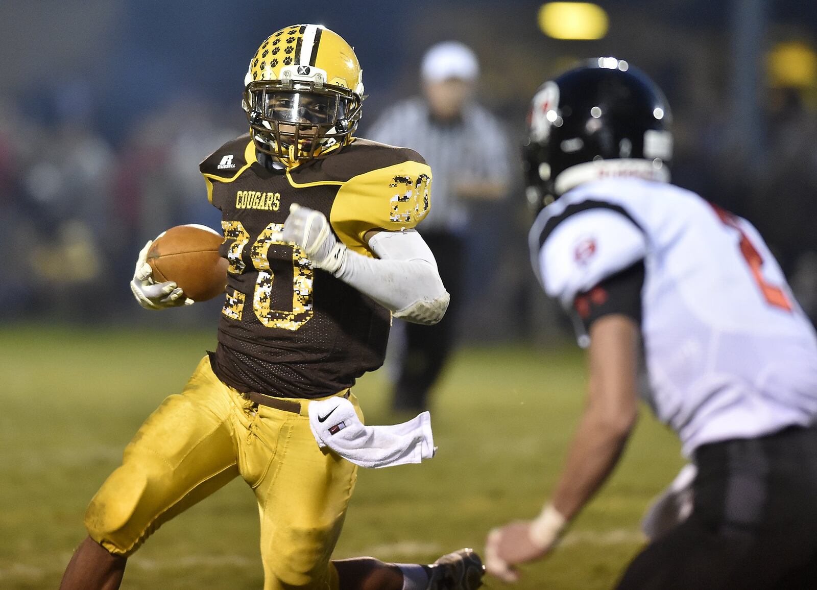 Kenton Ridge’s Jayden Davis tries to avoid a tackle by Tecumseh’s Kyle Terrel as he carries the ball during Friday’s game. Bill Lackey/Staff