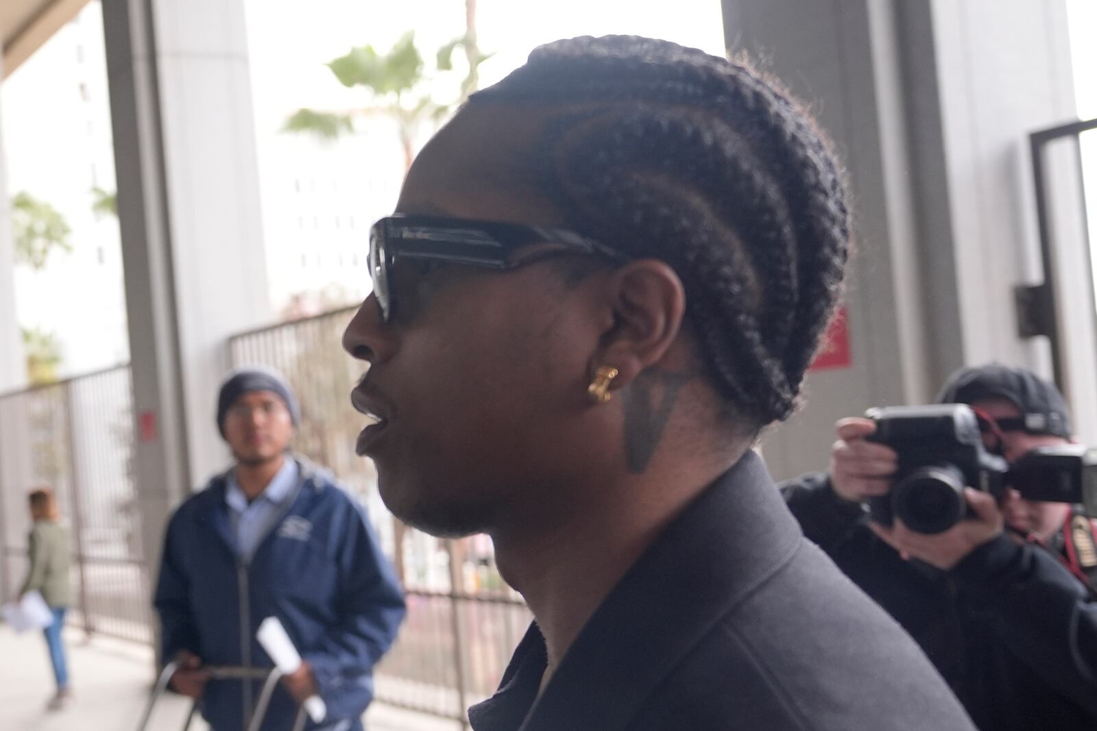 Grammy-nominated rapper A$AP Rocky, center, facing two felony counts of assault with a semiautomatic firearm after allegedly shooting at a former friend in 2021, arrives at the Clara Shortridge Foltz Criminal Justice Center in Los Angeles, Wednesday, Jan. 22, 2025. (AP Photo/Damian Dovarganes)