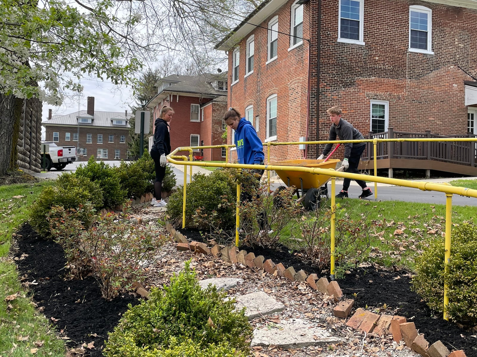 Roughly 50 volunteers from several organizations worked at Oesterlen on Friday to clean up its gardens. Photo provided by Niki Sage.