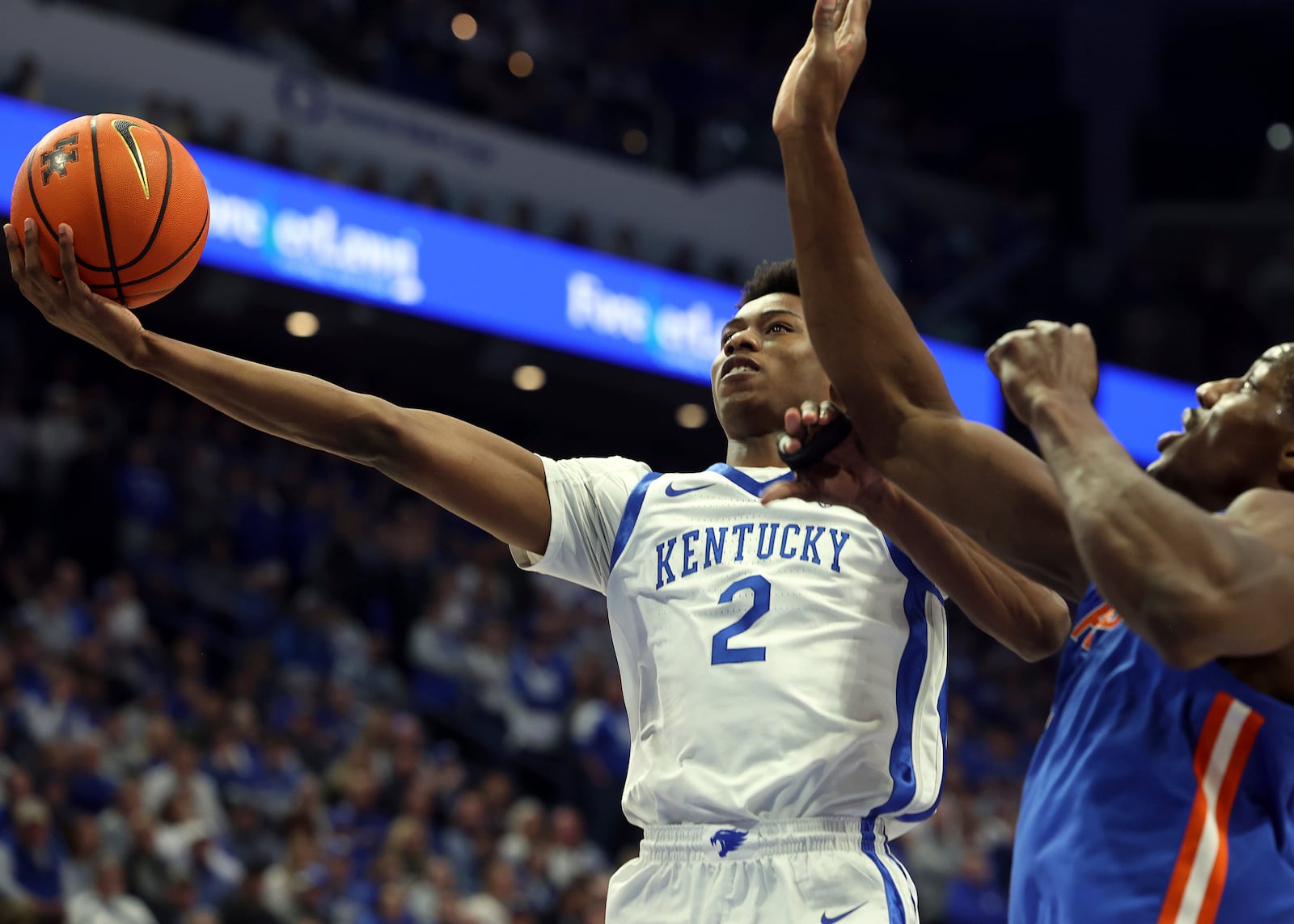 Kentucky's Jaxson Robinson (2) shoots while pressured by Florida's Rueben Chinyelu, right, during the first half of an NCAA college basketball game in Lexington, Ky., Saturday, Jan. 4, 2025. (AP Photo/James Crisp)