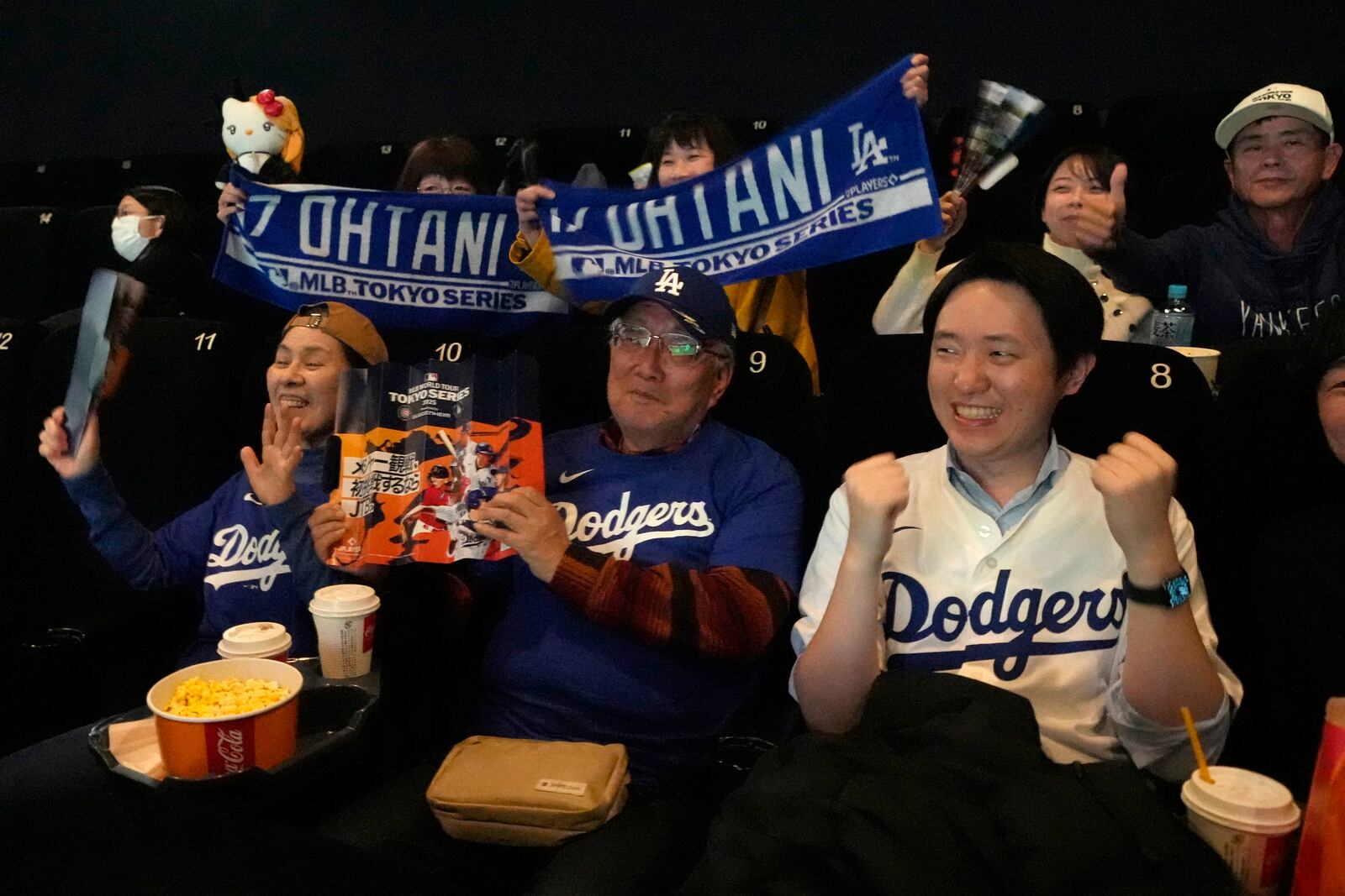 People wait before a public viewing of an MLB Japan Series baseball game between the Los Angeles Dodgers and the Chicago Cubs at Tokyo Dome, in Tokyo, Tuesday, March 18, 2025. (AP Photo/Shuji Kajiyama)