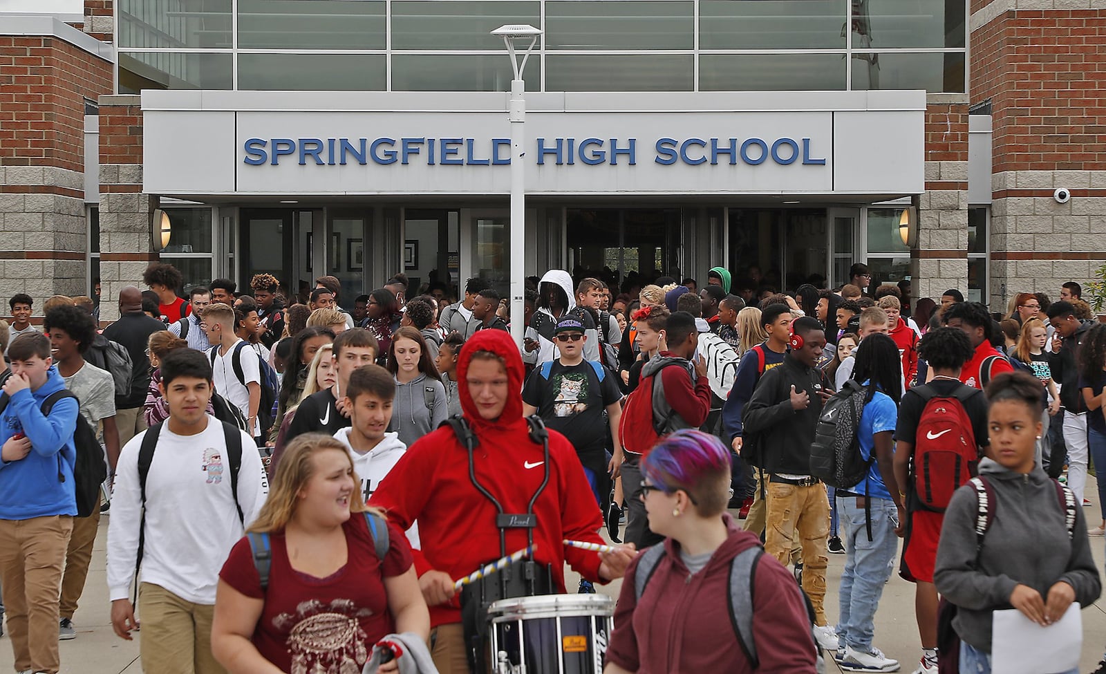 The students at Springfield High School exit the school building after school Wednesday. Bill Lackey/Staff