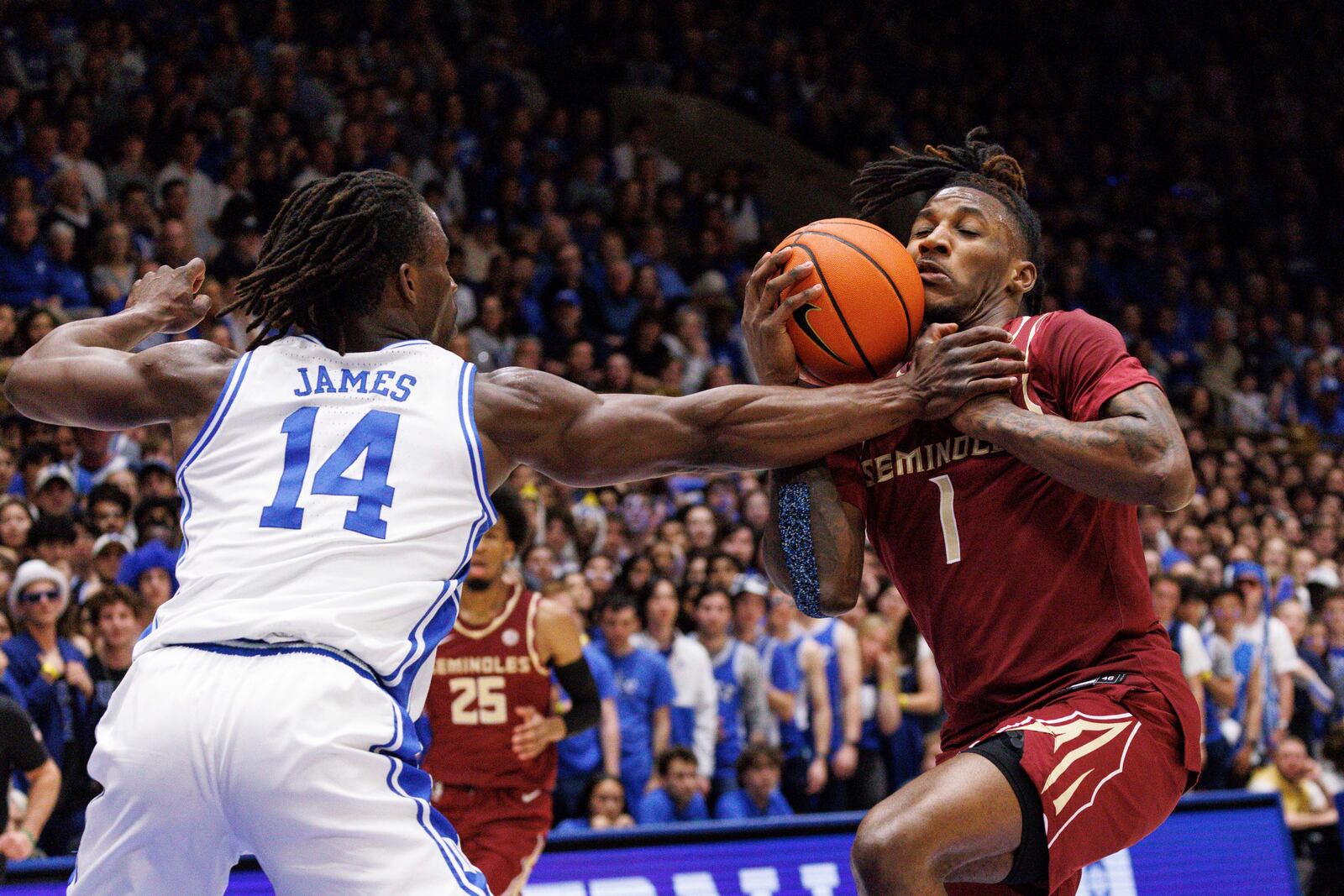 Florida State's Jamir Watkins (1) drives as Duke's Sion James (14) defends during the first half of an NCAA college basketball game in Durham, N.C., Saturday, March 1, 2025. (AP Photo/Ben McKeown)