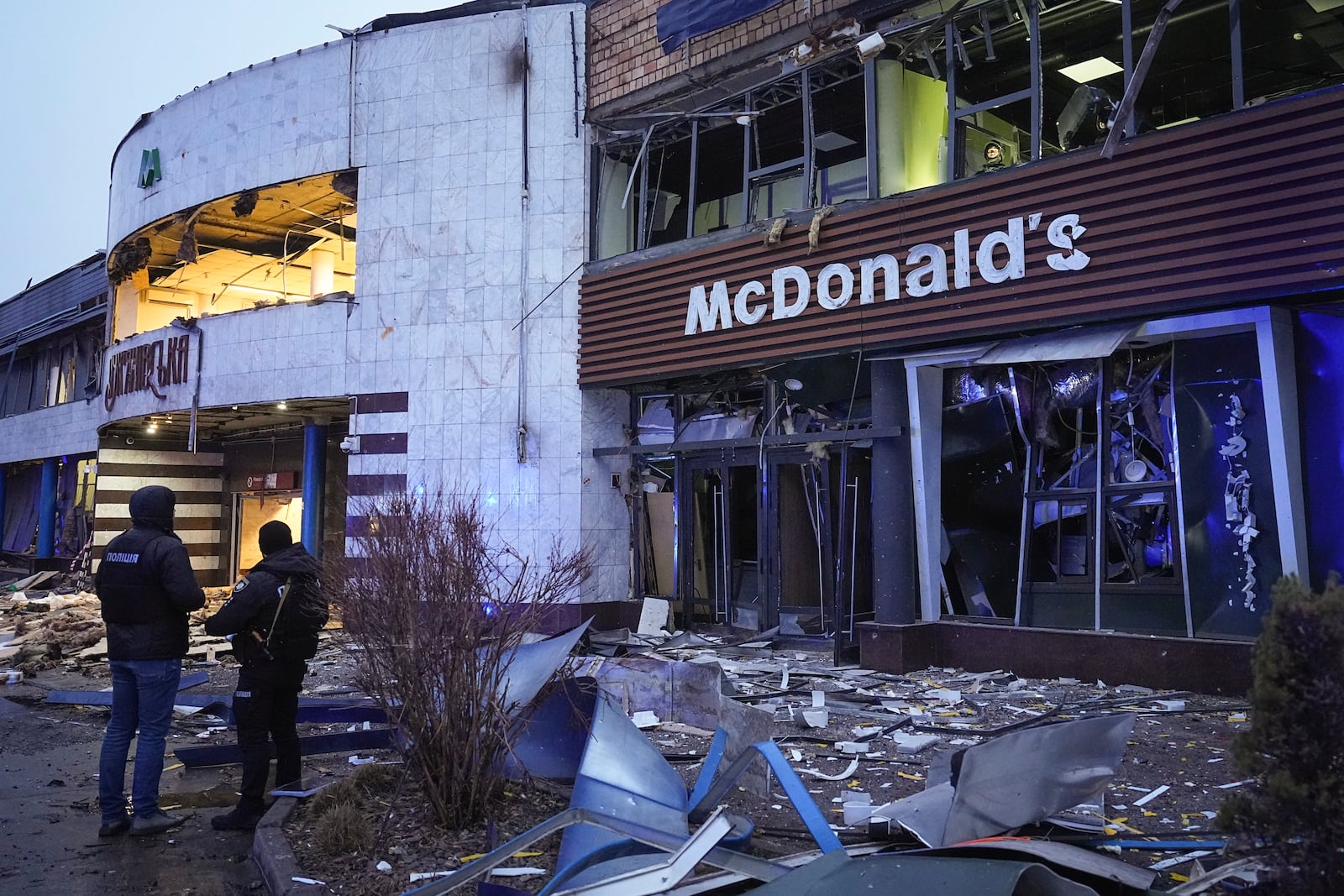 Police officers guard a building following a Russian missile attack in Kyiv, Ukraine, Saturday, Saturday, Jan. 18, 2025. (AP Photo/Efrem Lukatsky)