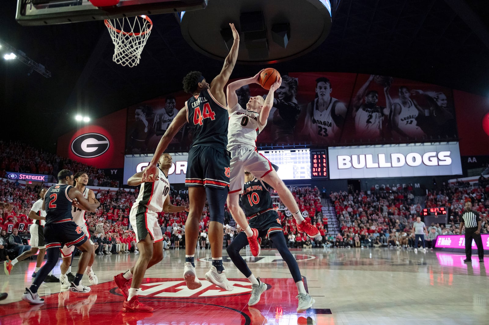 Georgia guard Blue Cain (0) shoots as Auburn center Dylan Cardwell (44) defends during the second half of an NCAA college basketball game, Saturday, Jan. 18, 2025, in Athens, Ga. (AP Photo/Kathryn Skeean)