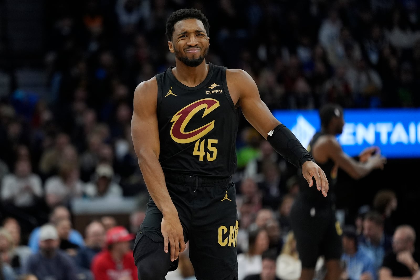 Cleveland Cavaliers guard Donovan Mitchell (45) reacts after falling during the first half of an NBA basketball game against the Minnesota Timberwolves, Saturday, Jan. 18, 2025, in Minneapolis. (AP Photo/Abbie Parr)