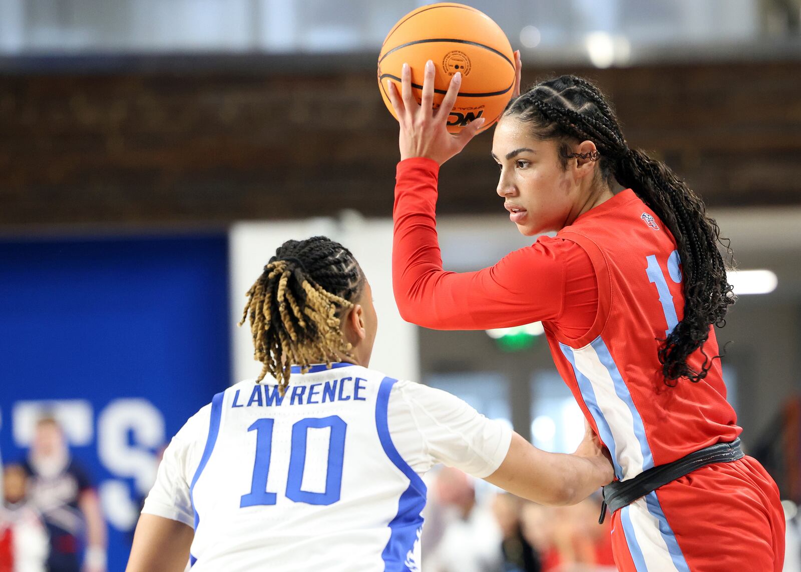 Liberty's Asia Boone, top, looks for an opening on Kentucky's Dazia Lawrence (10) during the first half in the first round of the NCAA college basketball tournament in Lexington, Ky., Friday, March 21, 2025. (AP Photo/James Crisp)