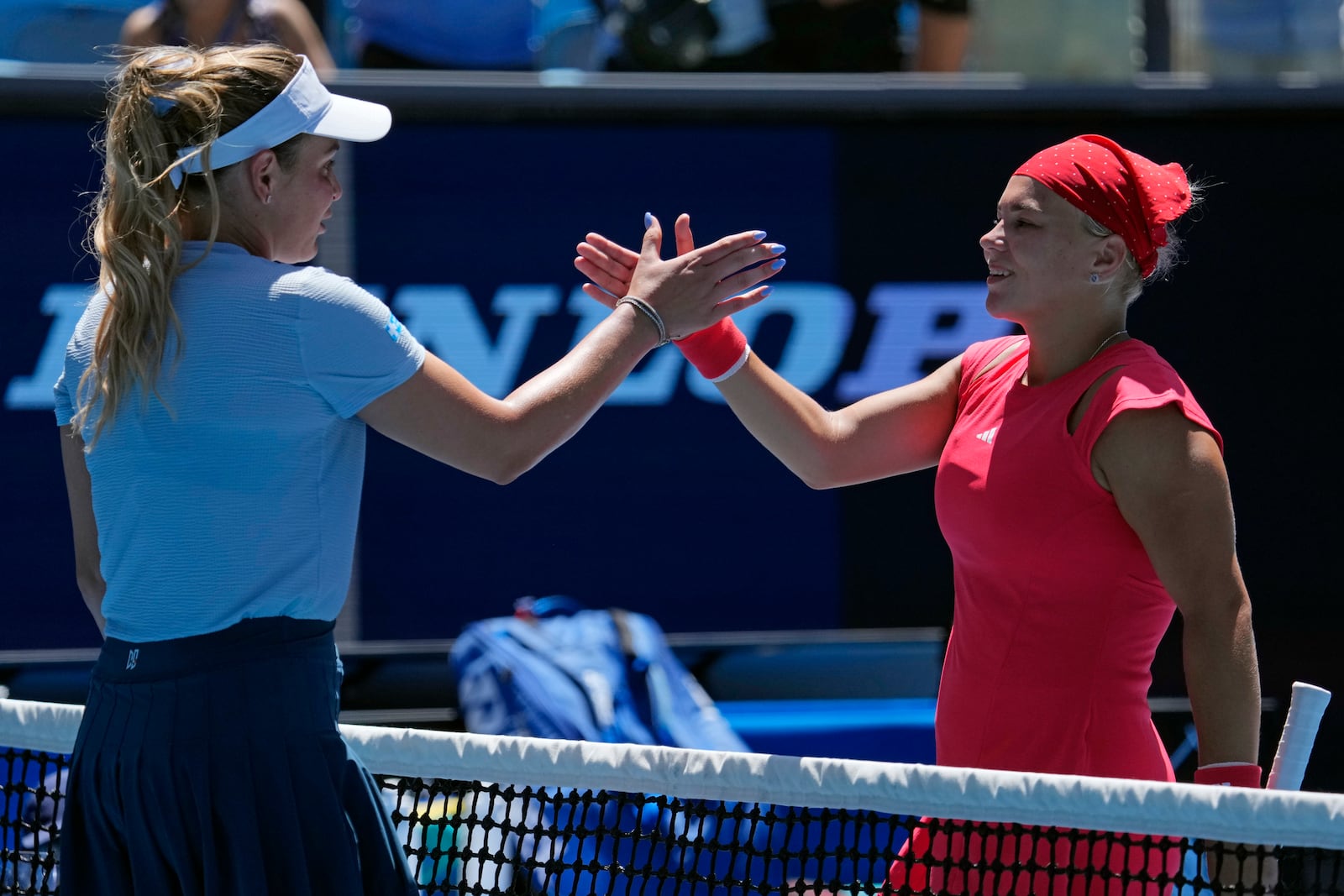 Diana Shnaider, right, of Russia congratulates Donna Vekic of Croatia following their third round match at the Australian Open tennis championship in Melbourne, Australia, Friday, Jan. 17, 2025. (AP Photo/Vincent Thian)