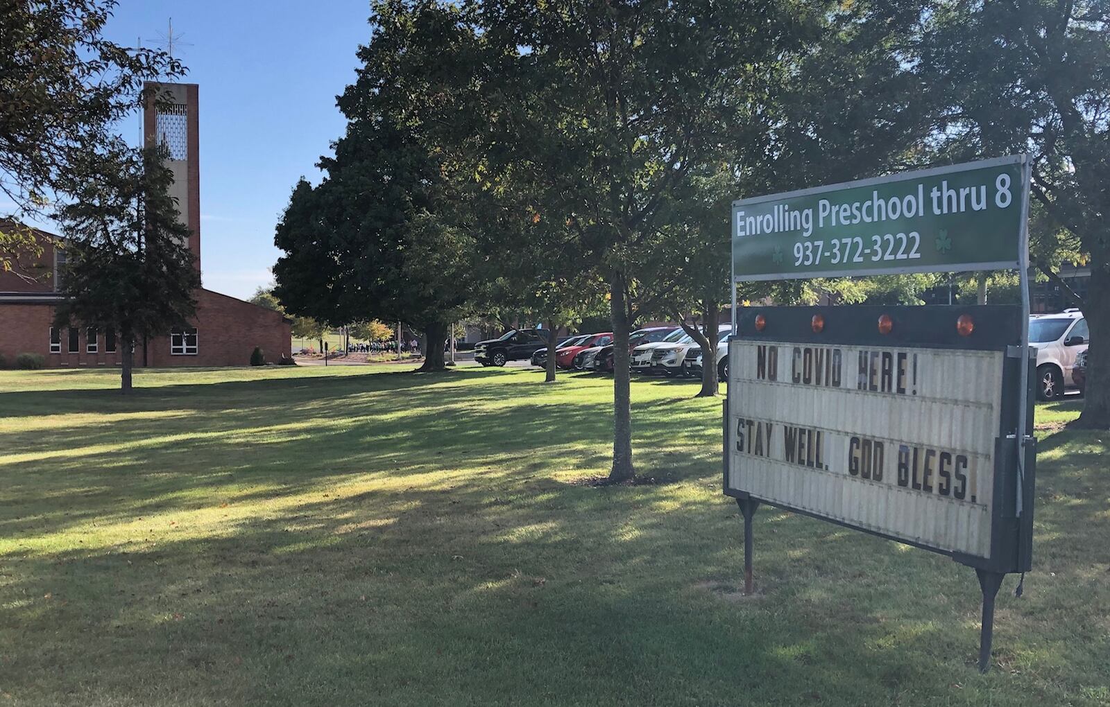 A sign outside St. Brigid's Catholic School in Xenia celebrates the school's lack of COVID-19 cases in the first month of in-person school on Friday, Sept. 25, 2020.