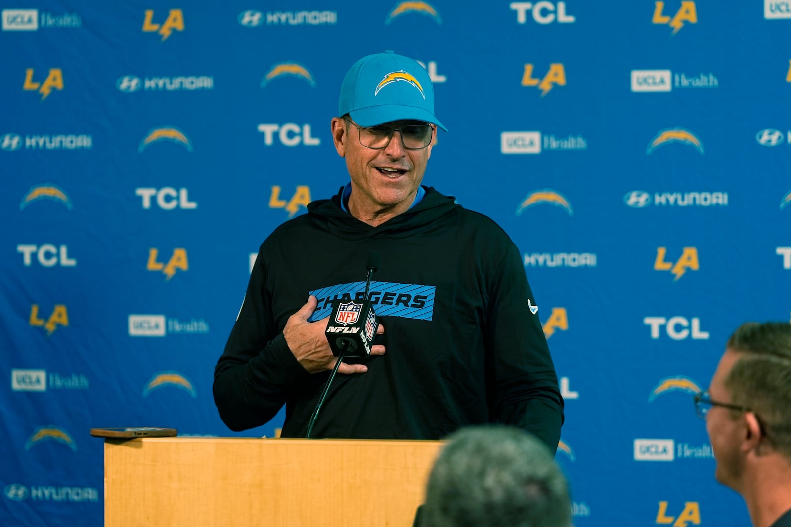 Los Angeles Chargers head coach Jim Harbaugh responds to questions during news conference after defeating the Denver Broncos in an NFL football game Sunday, Oct. 13, 2024, in Denver. (AP Photo/David Zalubowski)