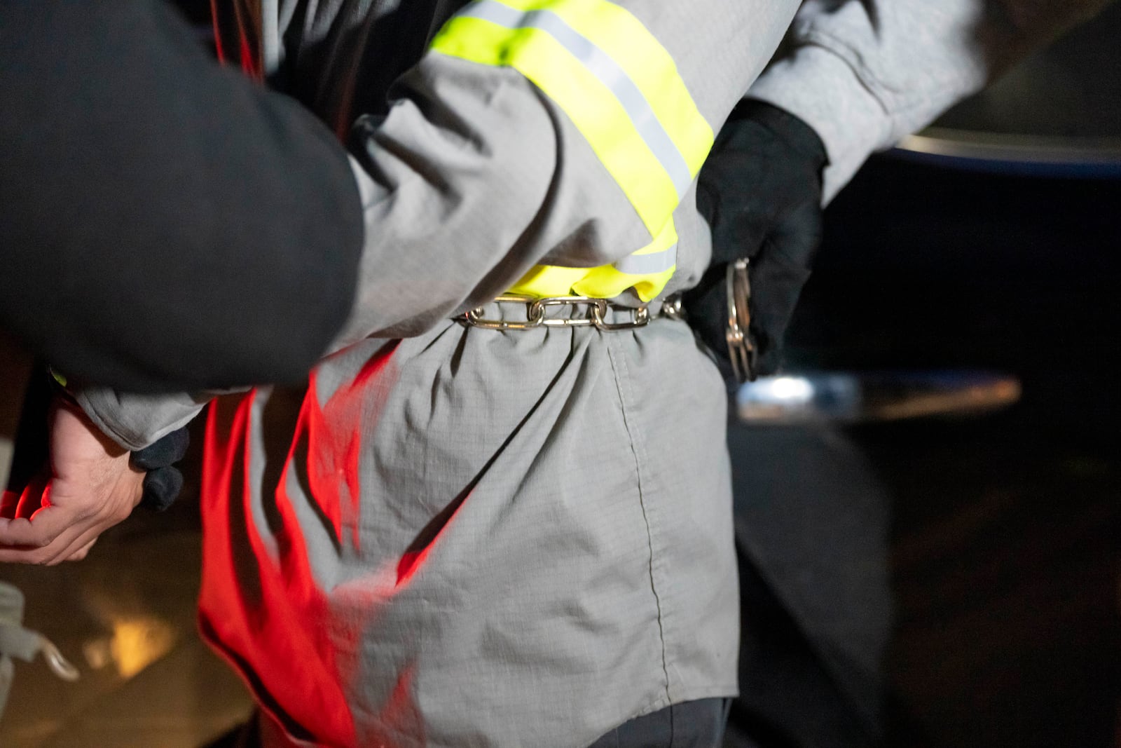 FILE - U.S. Immigration and Customs Enforcement officers use a chain to aid in restraining a detained person using handcuffs positioned in front, Monday, Jan. 27, 2025, in Silver Spring, Md. (AP Photo/Alex Brandon, File)