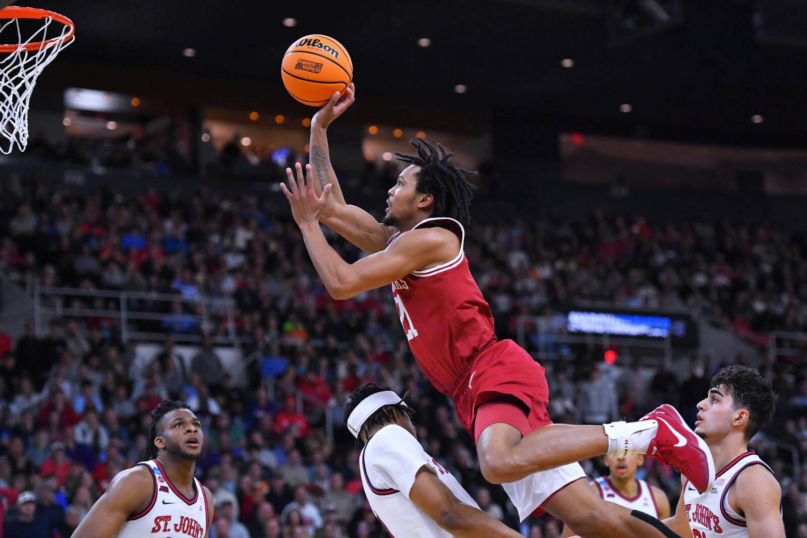 Arkansas guard D.J. Wagner (21) drives to the basket against St. John's during the first half in the second round of the NCAA college basketball tournament, Saturday, March 22, 2025, in Providence, R.I. (AP Photo/Steven Senne)