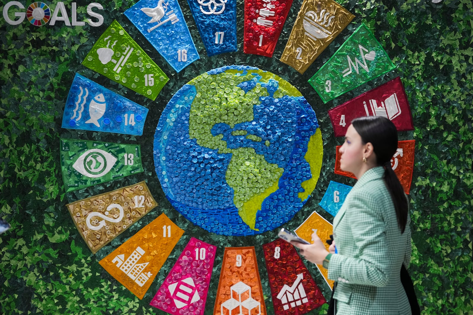 A person walks past art in the Turkey Pavilion at the COP29 U.N. Climate Summit, Thursday, Nov. 14, 2024, in Baku, Azerbaijan. (AP Photo/Sergei Grits)