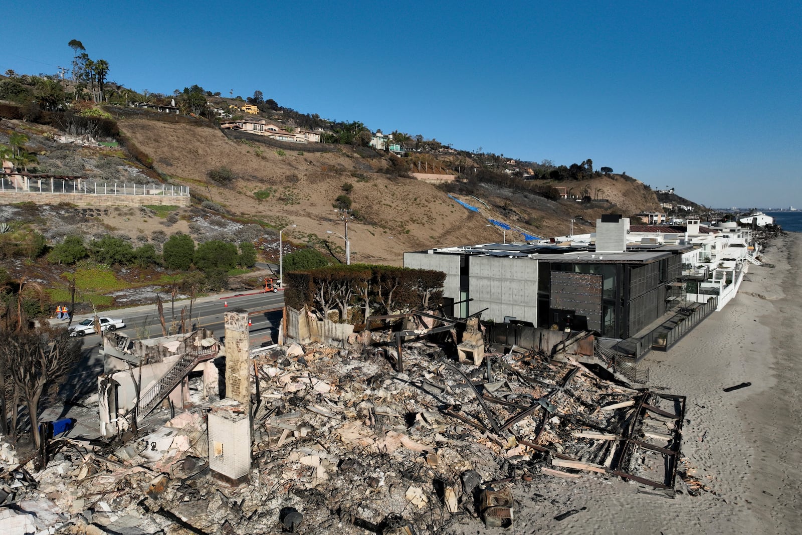 An aerial view shows the devastation from the Palisades Fire on beachfront homes Wednesday, Jan. 15, 2025 in Malibu, Calif. (AP Photo/Jae C. Hong)