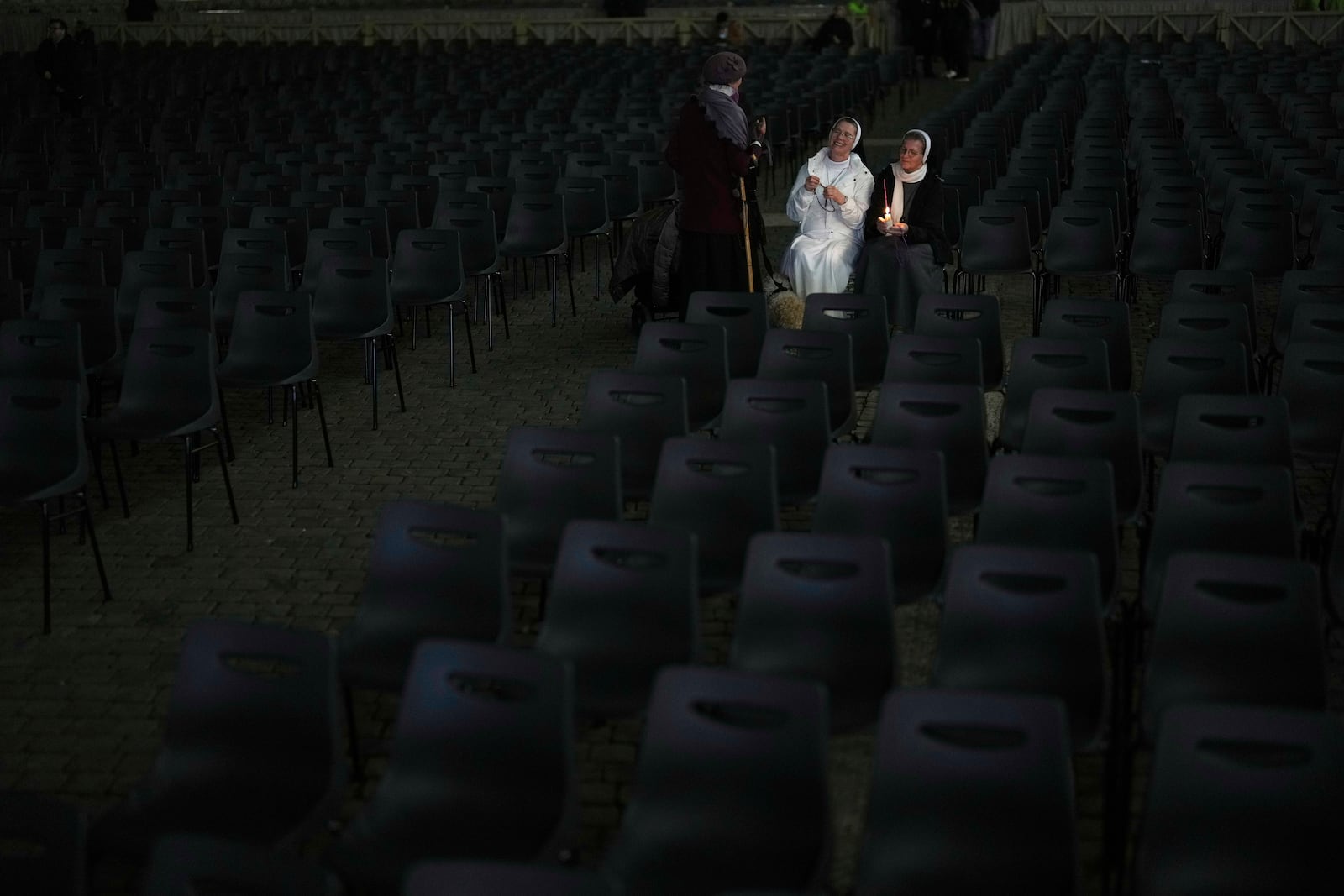 Catholic nuns gather with others worshippers for a prayer of the Rosary for Pope Francis in St. Peter's Square at The Vatican, Sunday, March 9, 2025. (AP Photo/Francisco Seco)