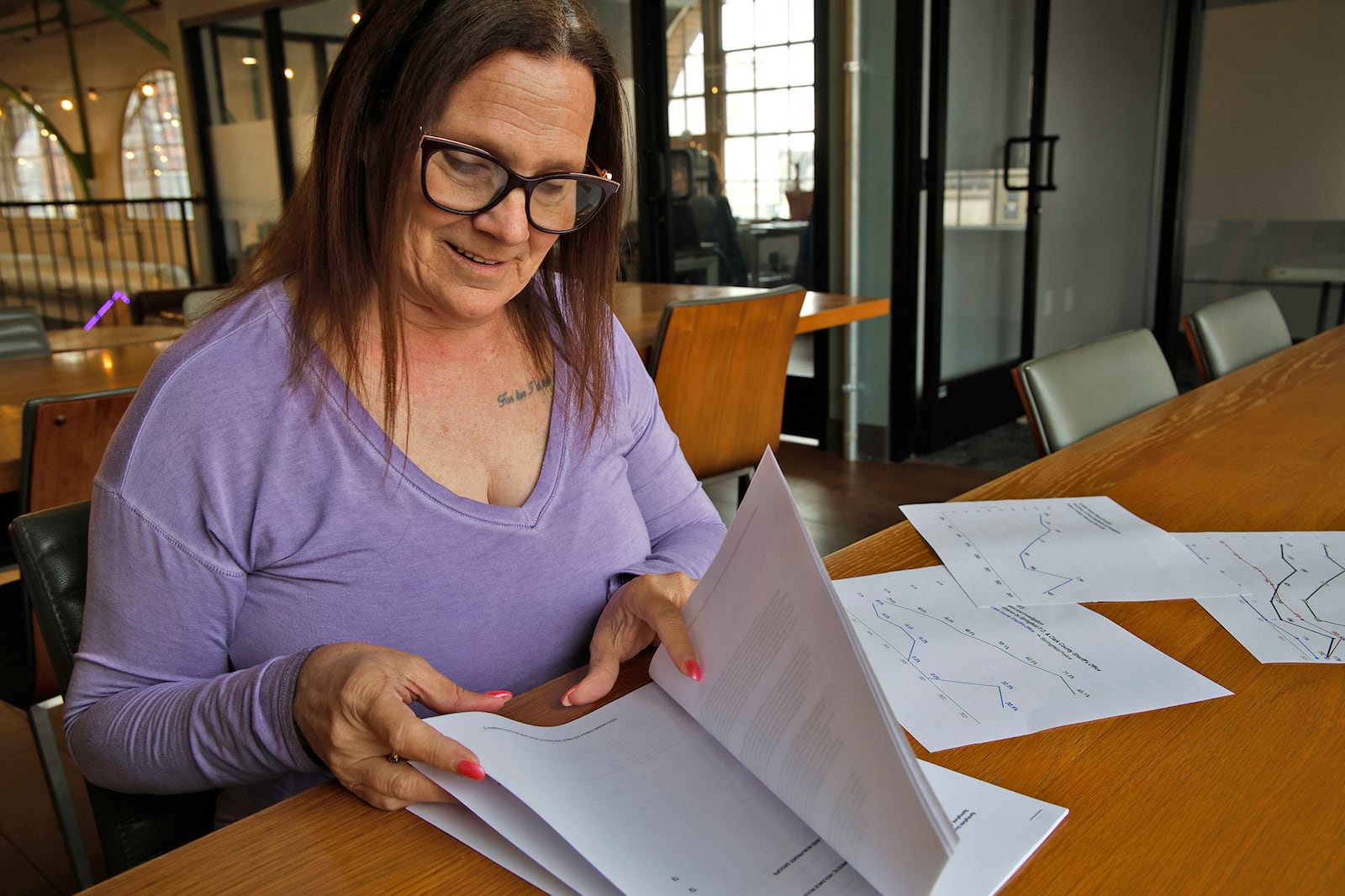 Beth Donahue, director of the Springfield Domestic Violence Coalition, looks over a report on Clark County's Domestic Violence incidents Wednesday, April 3, 2024. BILL LACKEY/STAFF