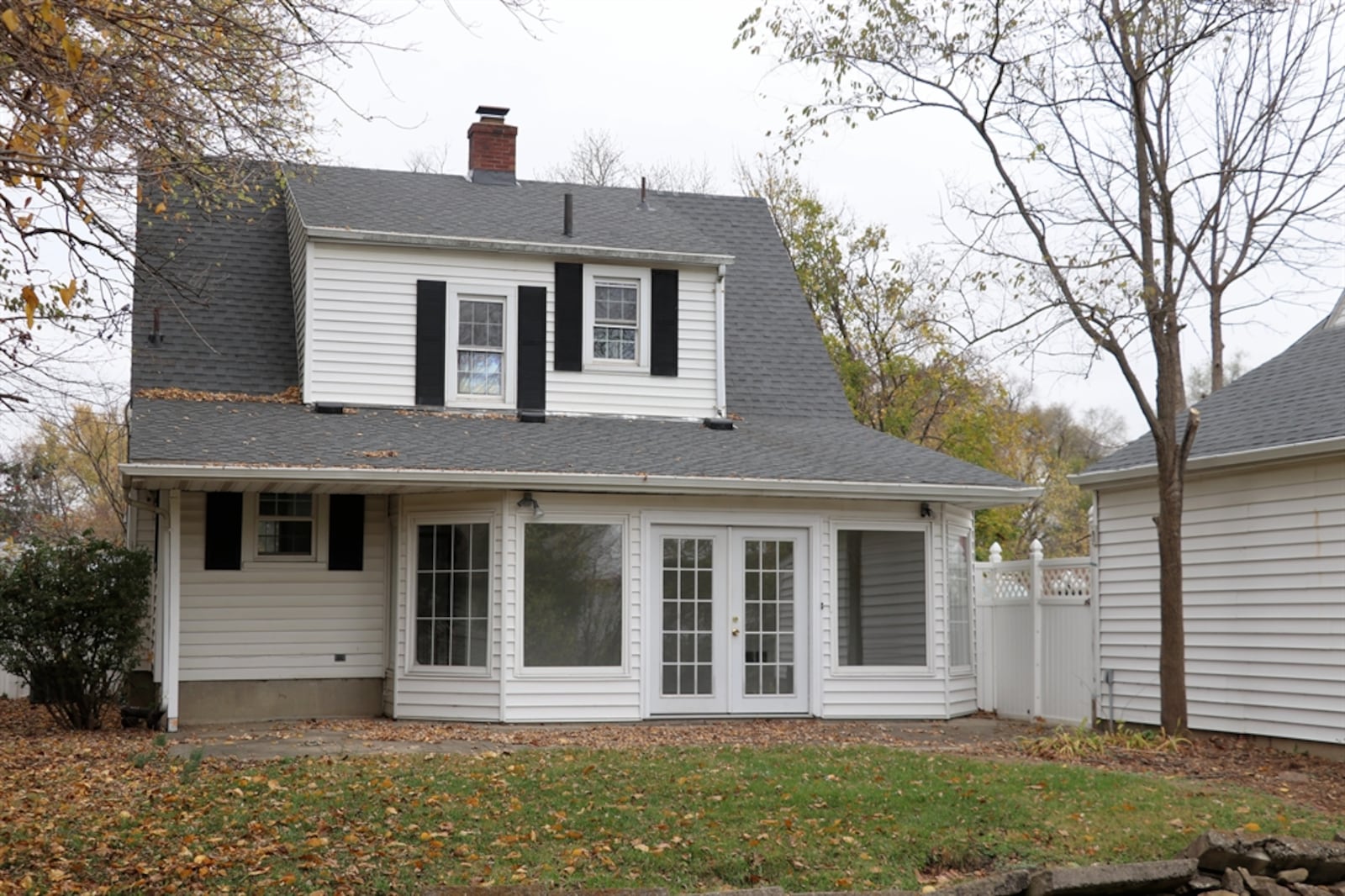 Walls of windows flank double glad-doors and provide panoramic views of the semi-private backyard. 