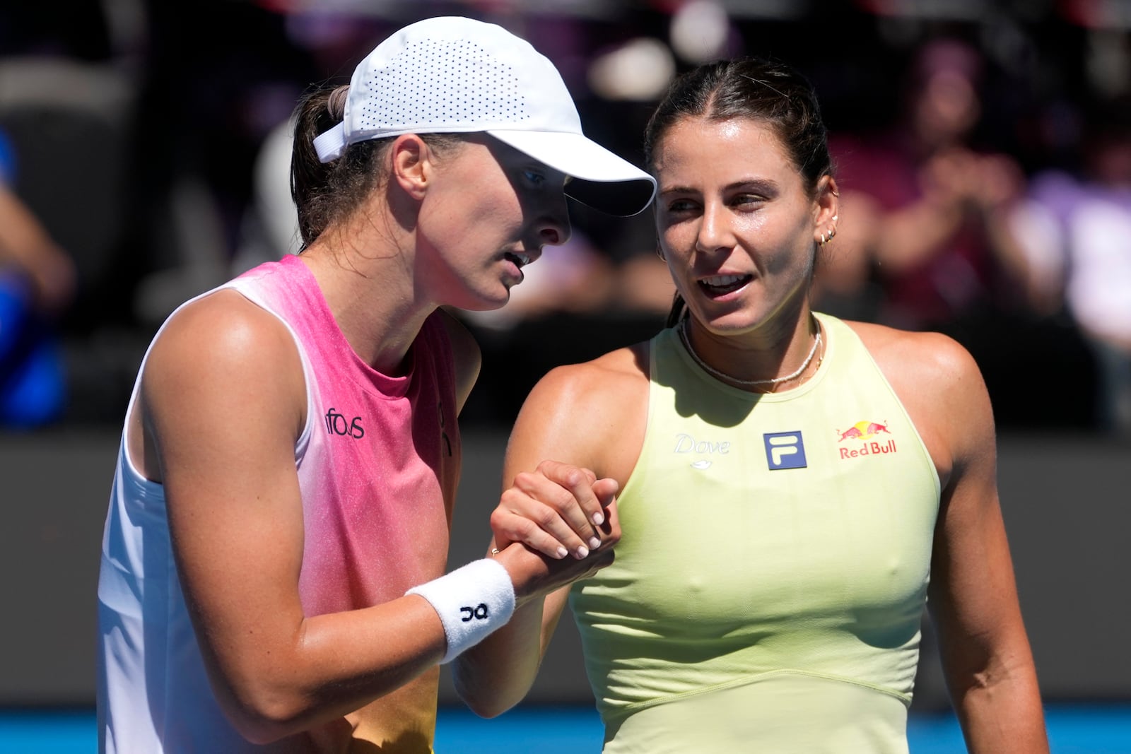 Iga Swiatek, left, of Poland, is congratulated by Emma Navarro of the U.S. following their quarterfinal match at the Australian Open tennis championship in Melbourne, Australia, Wednesday, Jan. 22, 2025. (AP Photo/Asanka Brendon Ratnayake)