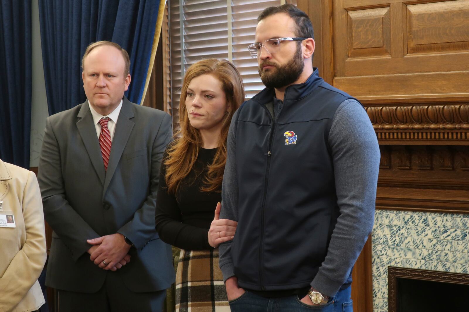 Mike Burgess, left, policy and outreach director for the Disability Rights Center of Kansas; Tayler Cantrell, center, of Topeka, Kan., and her husband, right, John Cantrell, look on during a news conference on how a lawsuit filed by state attorneys general in Texas could undermine federal anti-discrimination laws protecting disabled people, Monday, Feb. 17, 2025, at the Statehouse in Topeka. The Cantrells have a disabled 4-year-old son. (AP Photo/John Hanna)