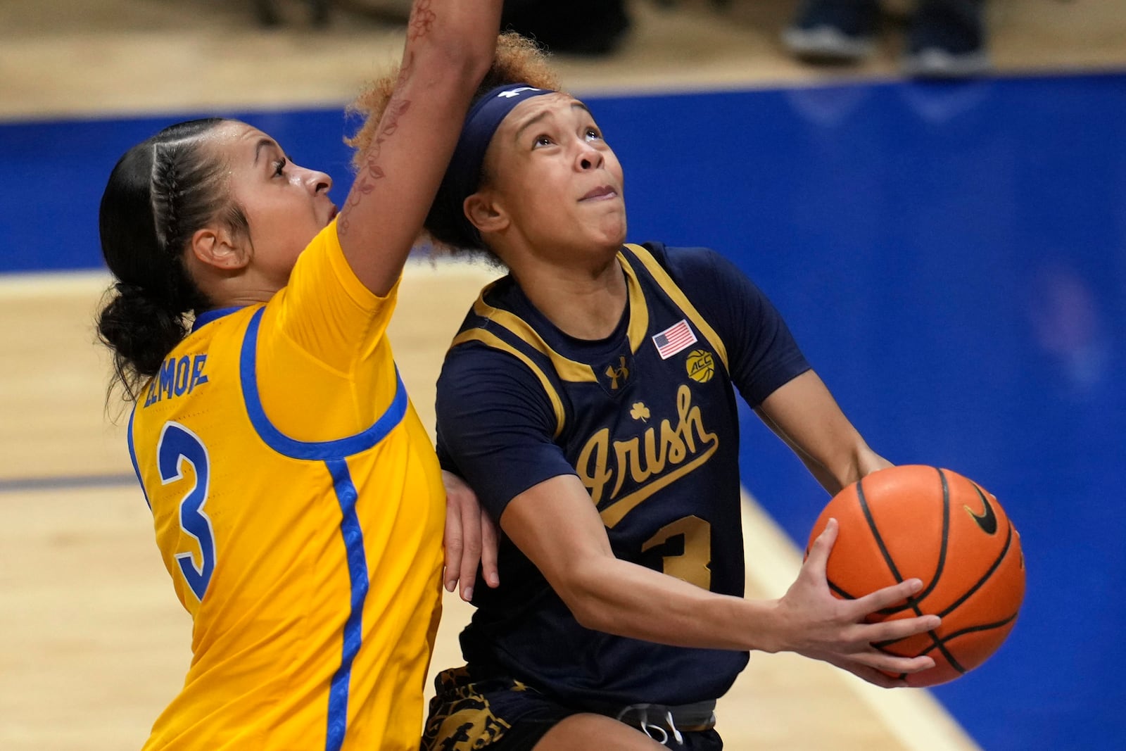 Notre Dame's Hannah Hidalgo, right, is fouled by Pittsburgh's MaKayla Elmore during the first half of the an NCAA college basketball game in Pittsburgh, Thursday, Feb. 13, 2025. (AP Photo/Gene J. Puskar)