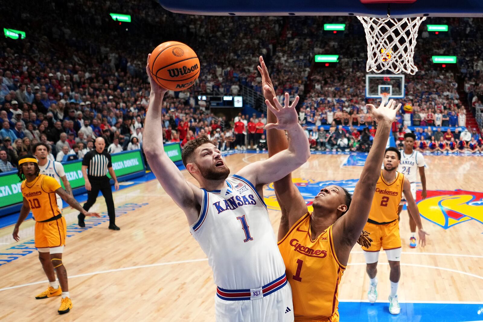 Kansas center Hunter Dickinson, center left, shoots over Iowa State center Dishon Jackson (1) during the first half of an NCAA college basketball game against Iowa State, Monday, Feb. 3, 2025, in Lawrence, Kan. (AP Photo/Charlie Riedel)