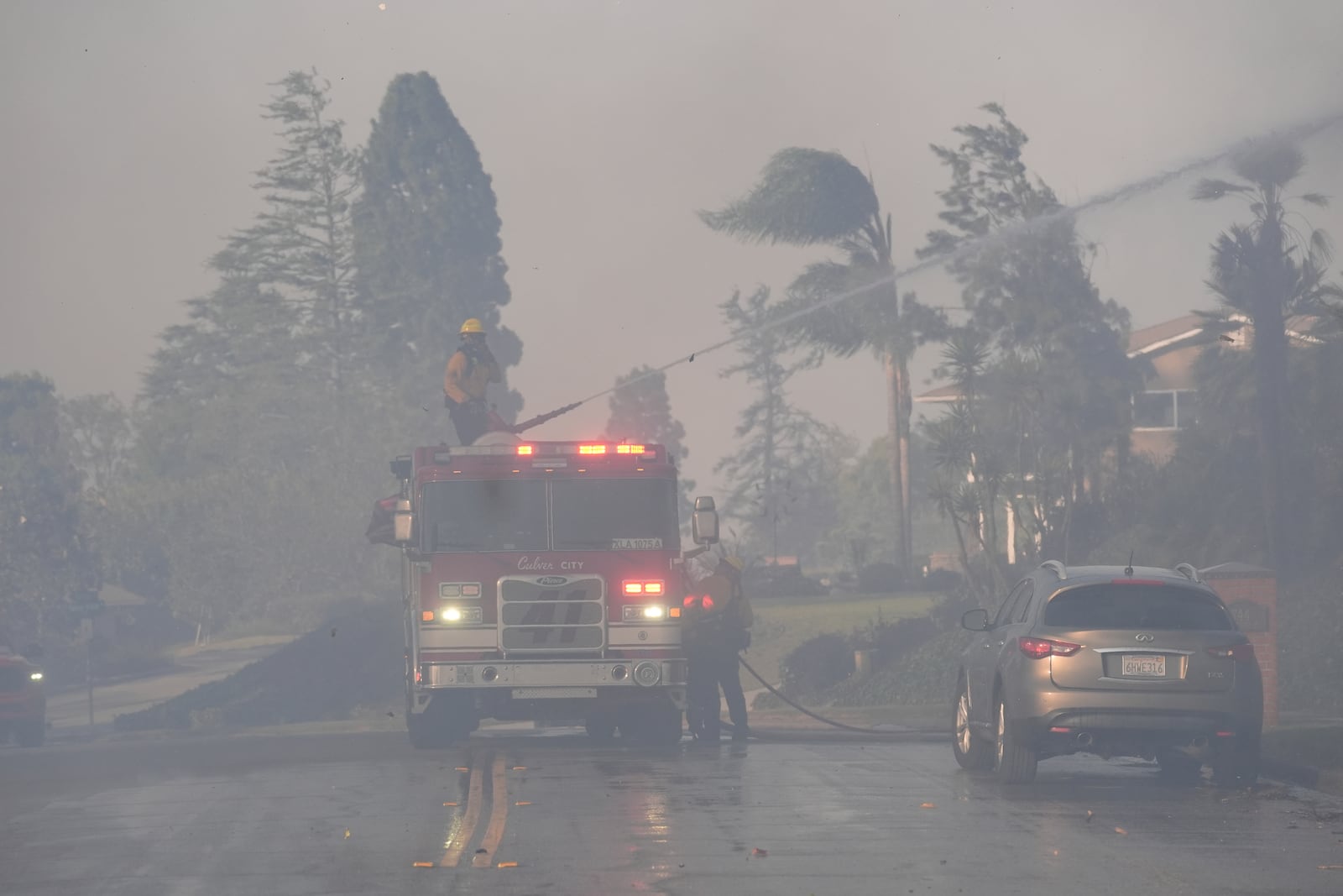 Firefighters work through heavy winds and smoke in the Mountain fire, Wednesday, Nov. 6, 2024, in Camarillo, Calif. (AP Photo/Marcio Jose Sanchez)