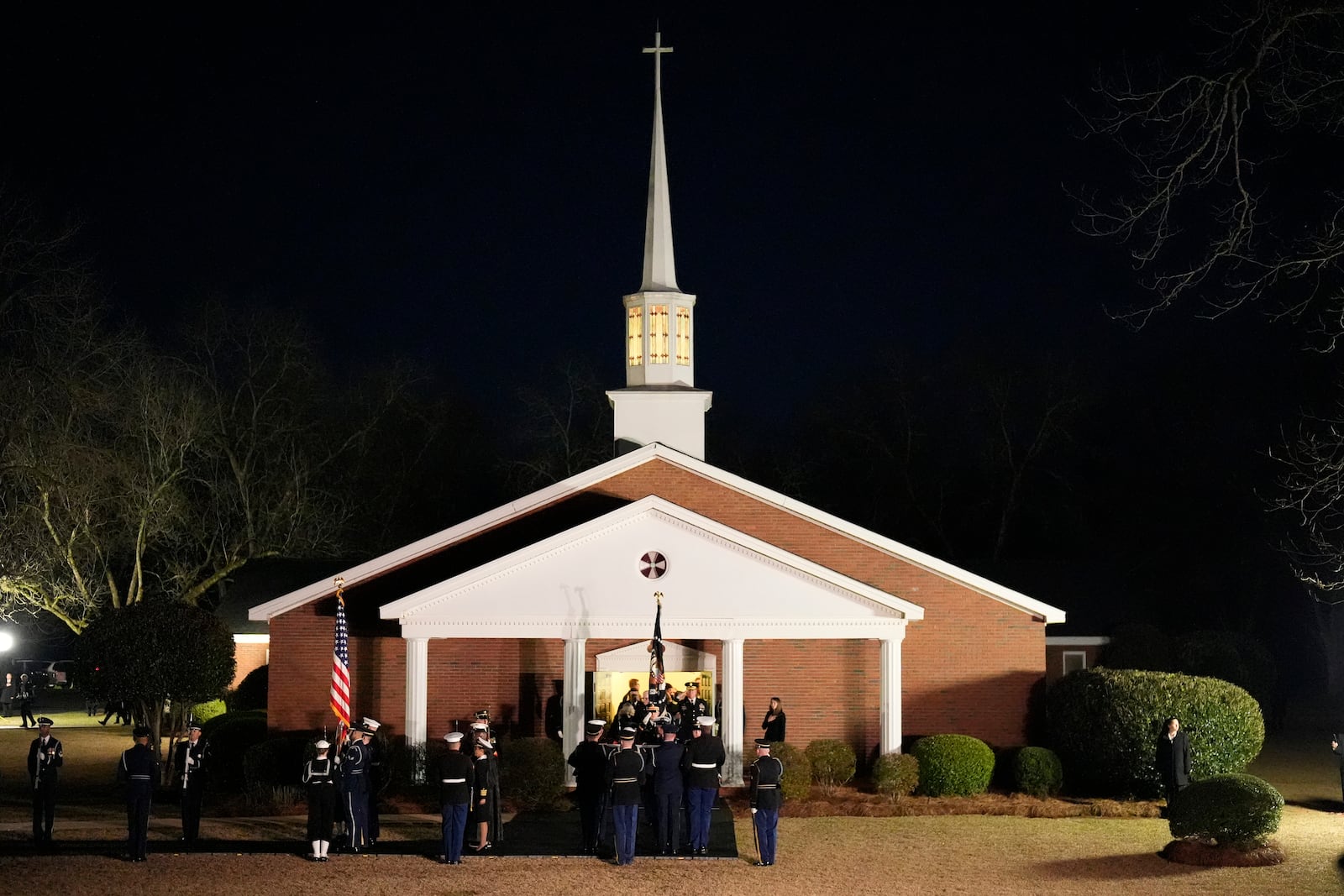 The flag-draped casket of former President Jimmy Carter is carried to a hearse after a funeral service at Maranatha Baptist Church, Thursday, Jan. 9, 2025, in Plains, Ga. (AP Photo/Mike Stewart)