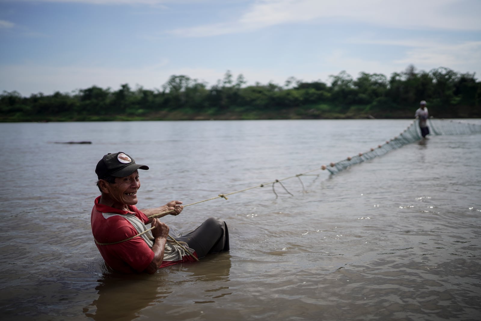 Marciano Flores, from the Cocama Indigenous community, fishes in the low levels of the Amazon River, on the outskirts of Leticia, Colombia, Monday, Oct. 21, 2024. (AP Photo/Ivan Valencia)