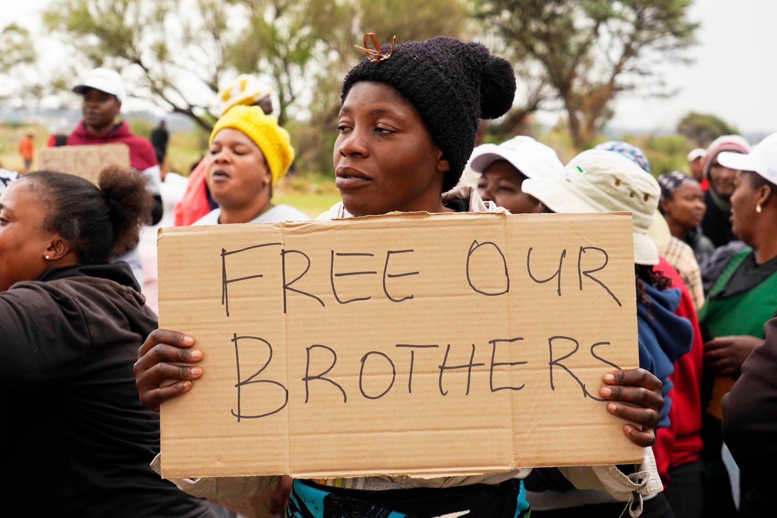 Relatives and friends protest near a reformed gold mineshaft where illegal miners are trapped in Stilfontein, South Africa, Friday, Nov. 15, 2024. (AP Photo/Denis Farrell)