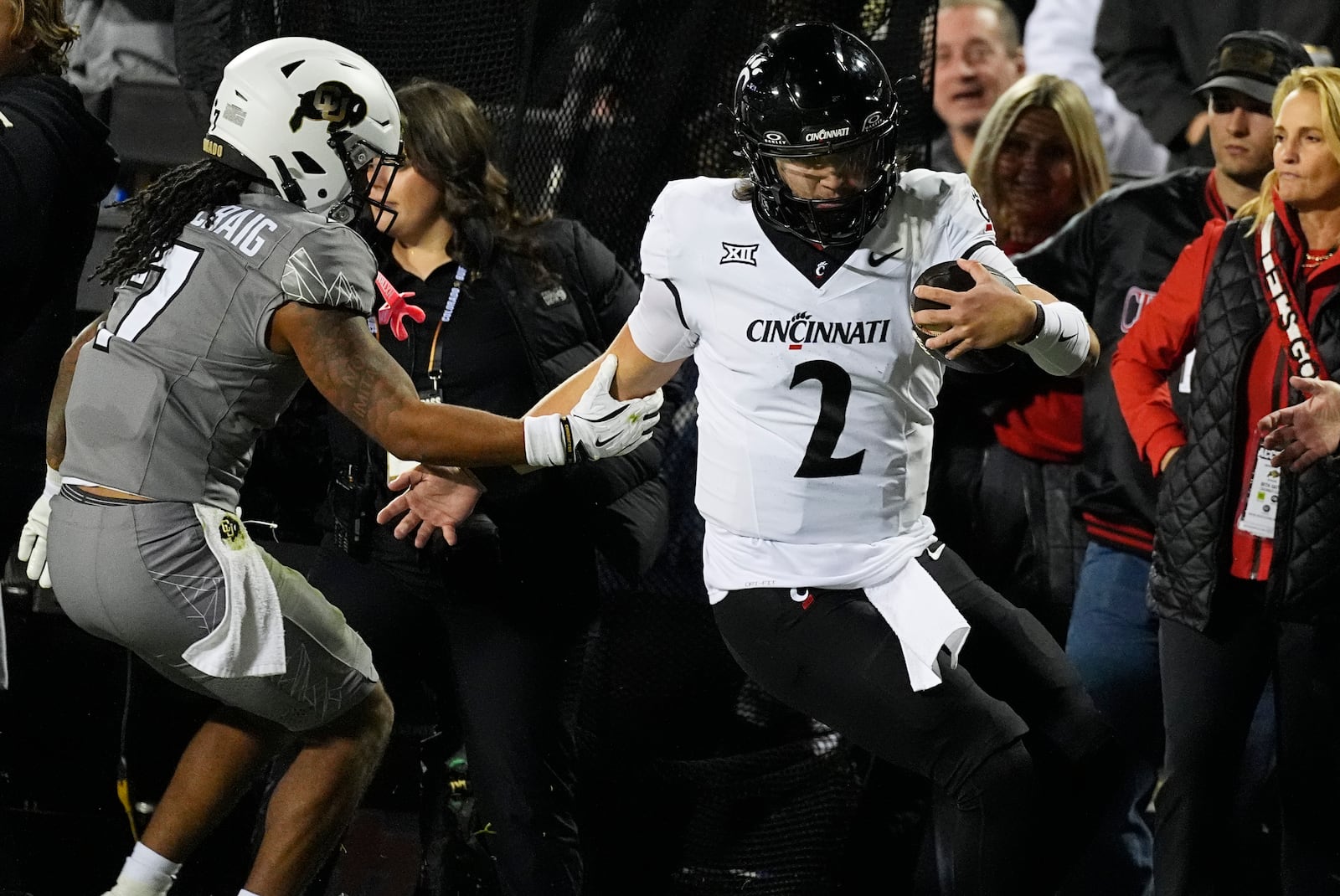 Colorado safety Cam'Ron Silmon-Craig, left, pushes Cincinnati quarterback Brendan Sorsby out of bounds after a short gain in the first half of an NCAA college football game Saturday, Oct. 26, 2024, in Boulder, Colo. (AP Photo/David Zalubowski)