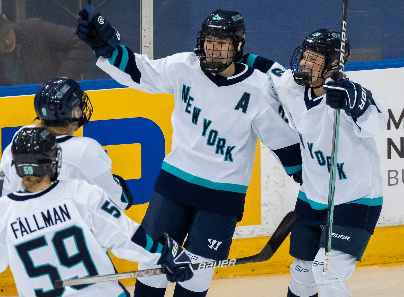 FILE - New York forward Alex Carpenter, center, is congratulated by teammates Paetyn Levis (19), Jade Downie-Landry (9) and Johanna Fallman after scoring against Toronto during the third period of a PWHL hockey game in Toronto, Ontario, Monday, Jan. 1, 2024. (Frank Gunn/The Canadian Press via AP, File)