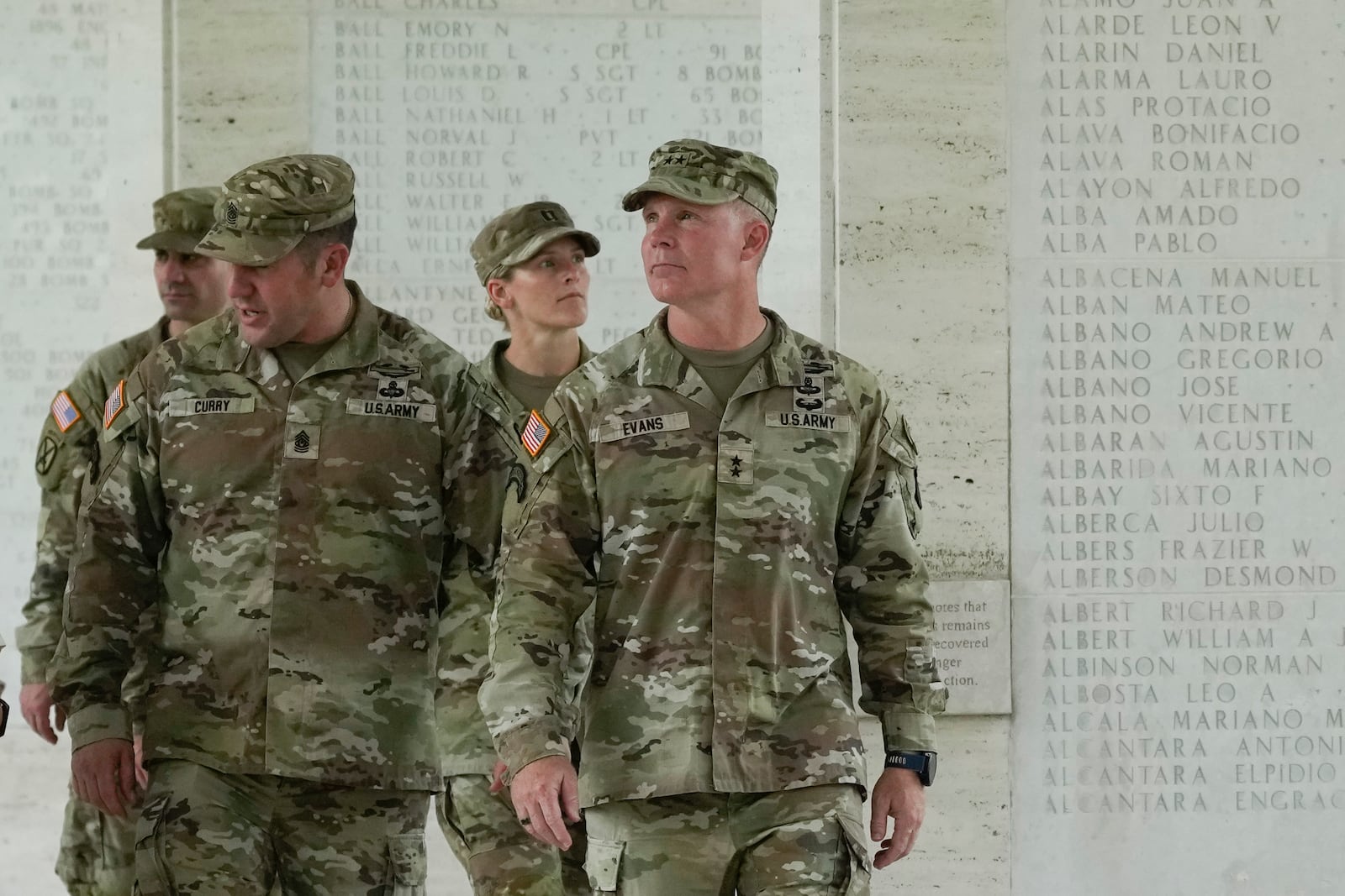 U.S. Maj. Gen. Marcus Evans, right, commanding general of the U.S. Army's 25th Infantry Division, looks at names of American soldiers who died during World War II that are carved on a wall at the Manila American Cemetery and Memorial in Taguig, Philippines on Monday, Oct. 21, 2024. (AP Photo/Aaron Favila)