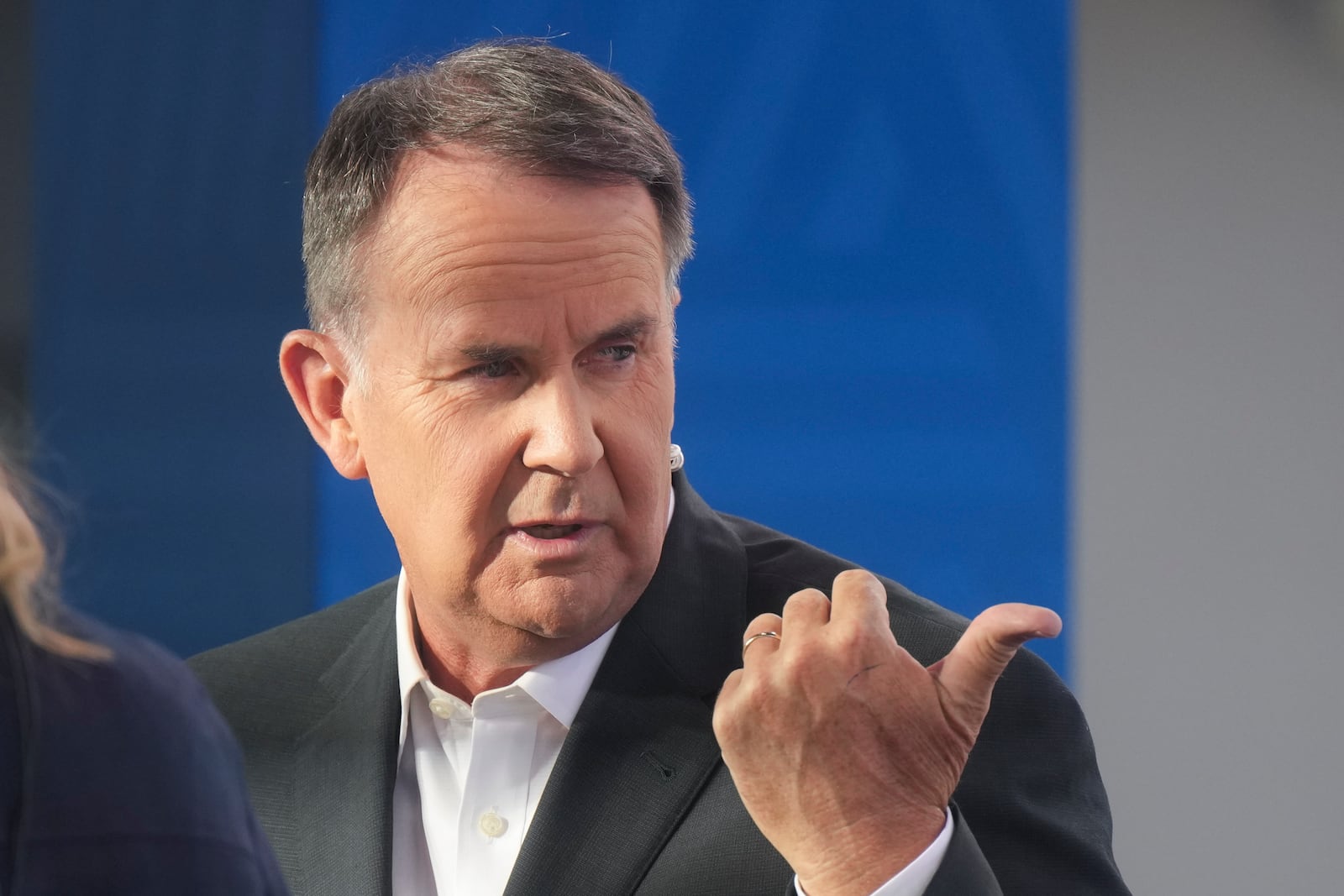 Television presenter Tony Jones during a live cross at Melbourne Park venue for the Australian Open tennis championship in Melbourne, Australia, Monday, Jan. 20, 2025. (AP Photo/Mark Baker)