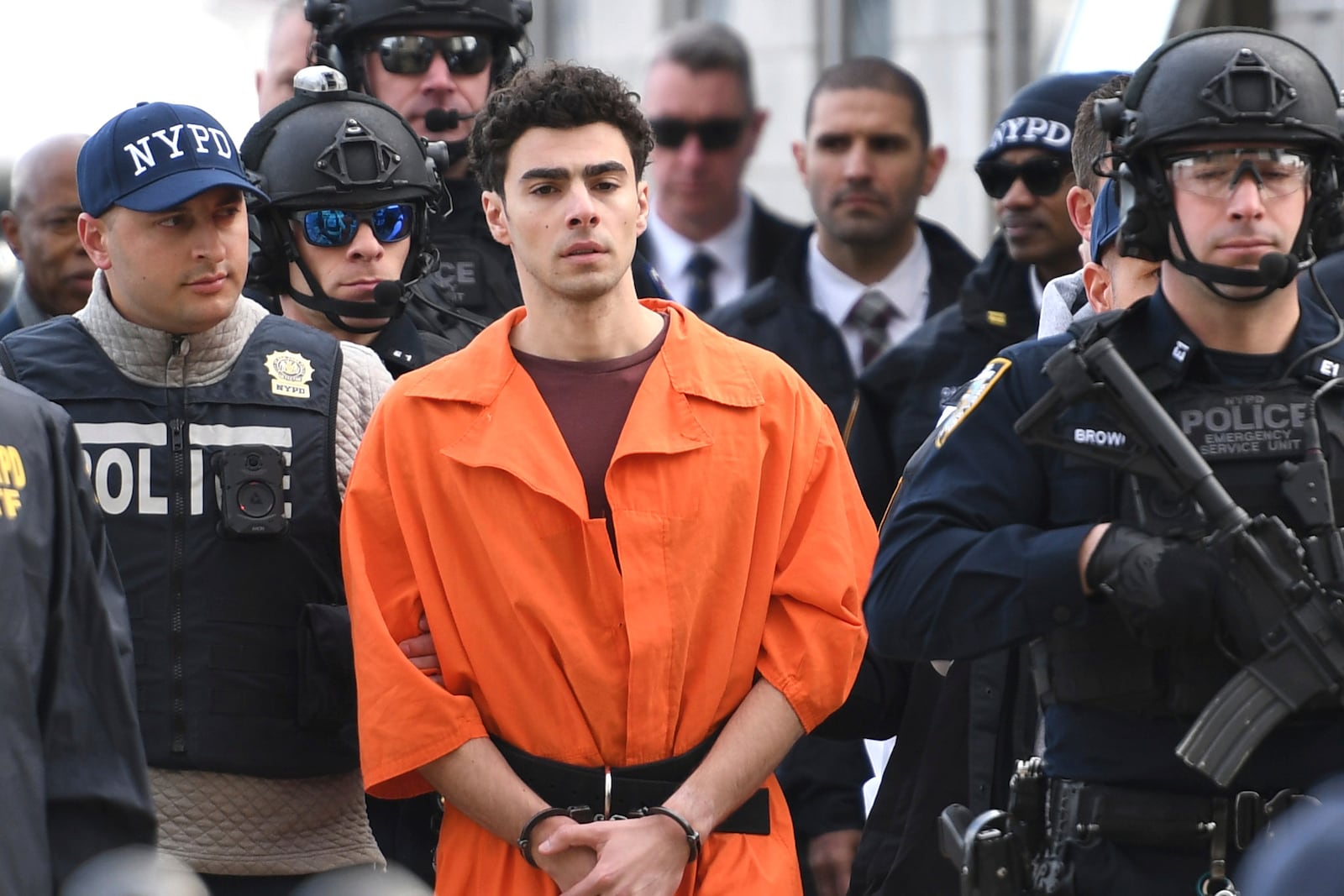 Luigi Mangione, a suspect in the fatal shooting of UnitedHealthcare CEO Brian Thompson, is escorted by police, Thursday, Dec. 19, 2024, in New York. (AP Photo/Pamela Smith)